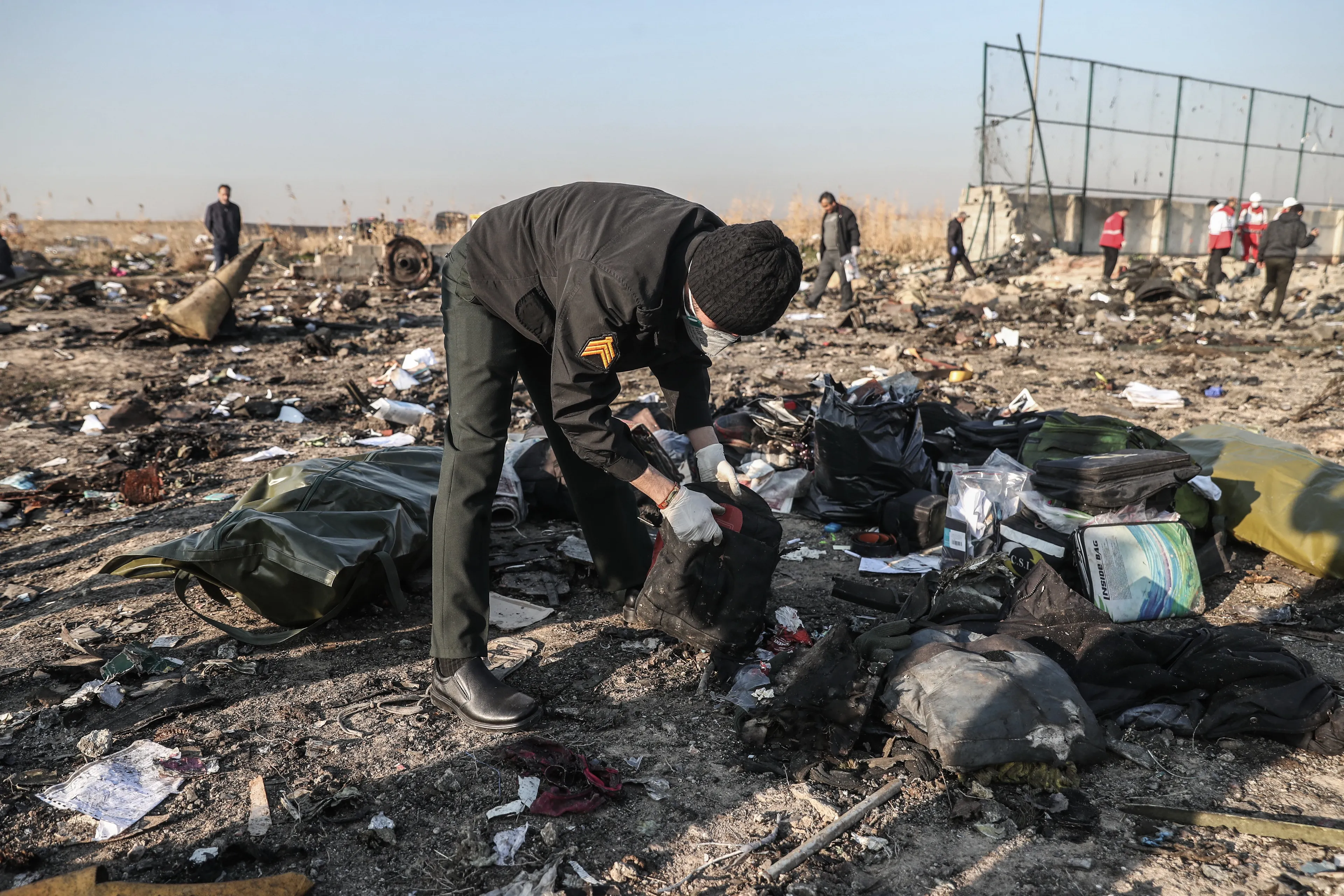 Rescuers search the debris at the crash site of the downed Ukrainian plane in Tehran (Mohammadreza Abbasi/Getty Images)