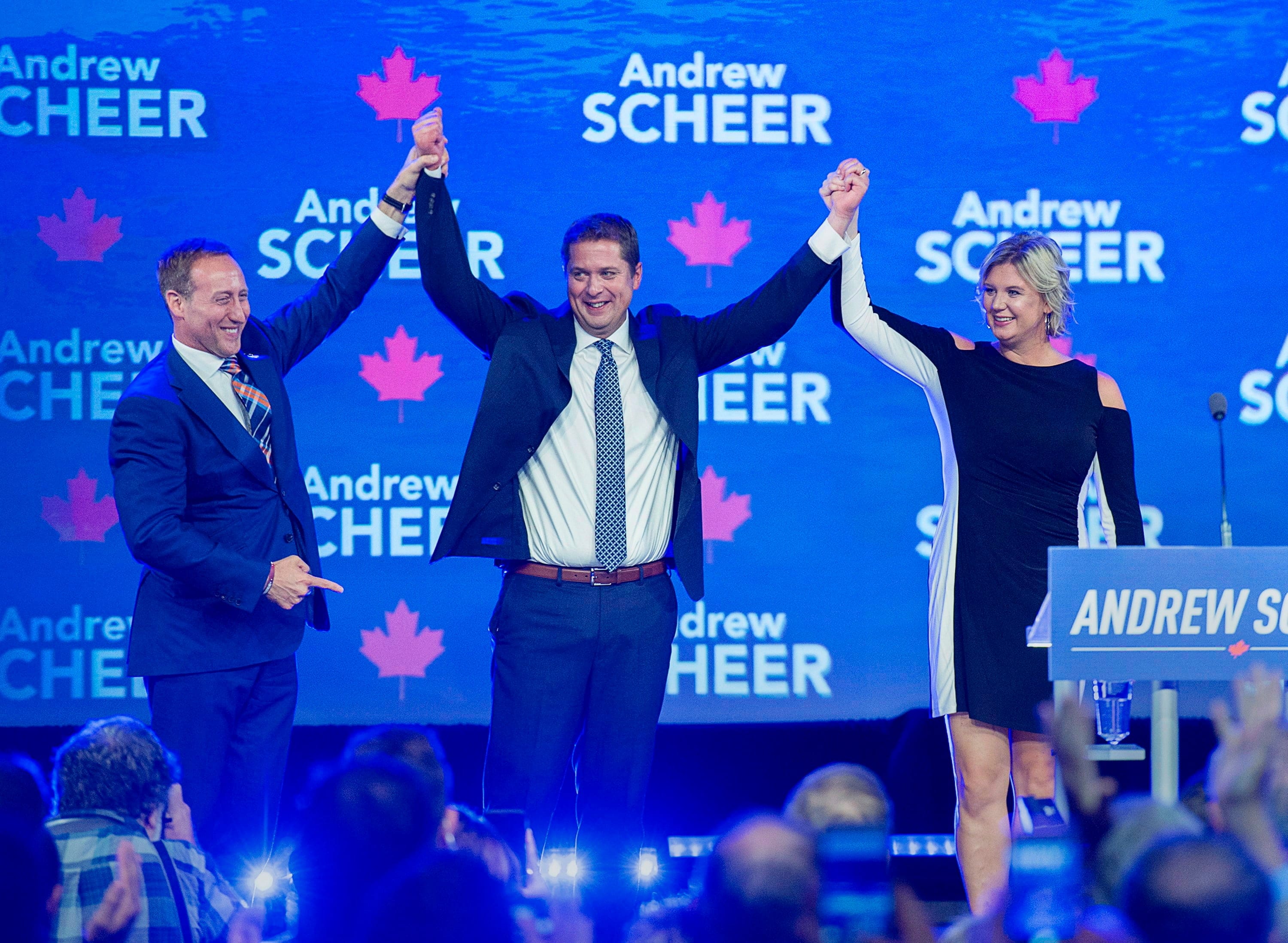 Conservative Party of Canada Leader Andrew Scheer, accompanied by his wife Jill, is introduced by former Conservative cabinet minister Peter MacKay, left, at the party's national policy convention in Halifax on Aug. 24, 2018. (Andrew Vaughan/CP)