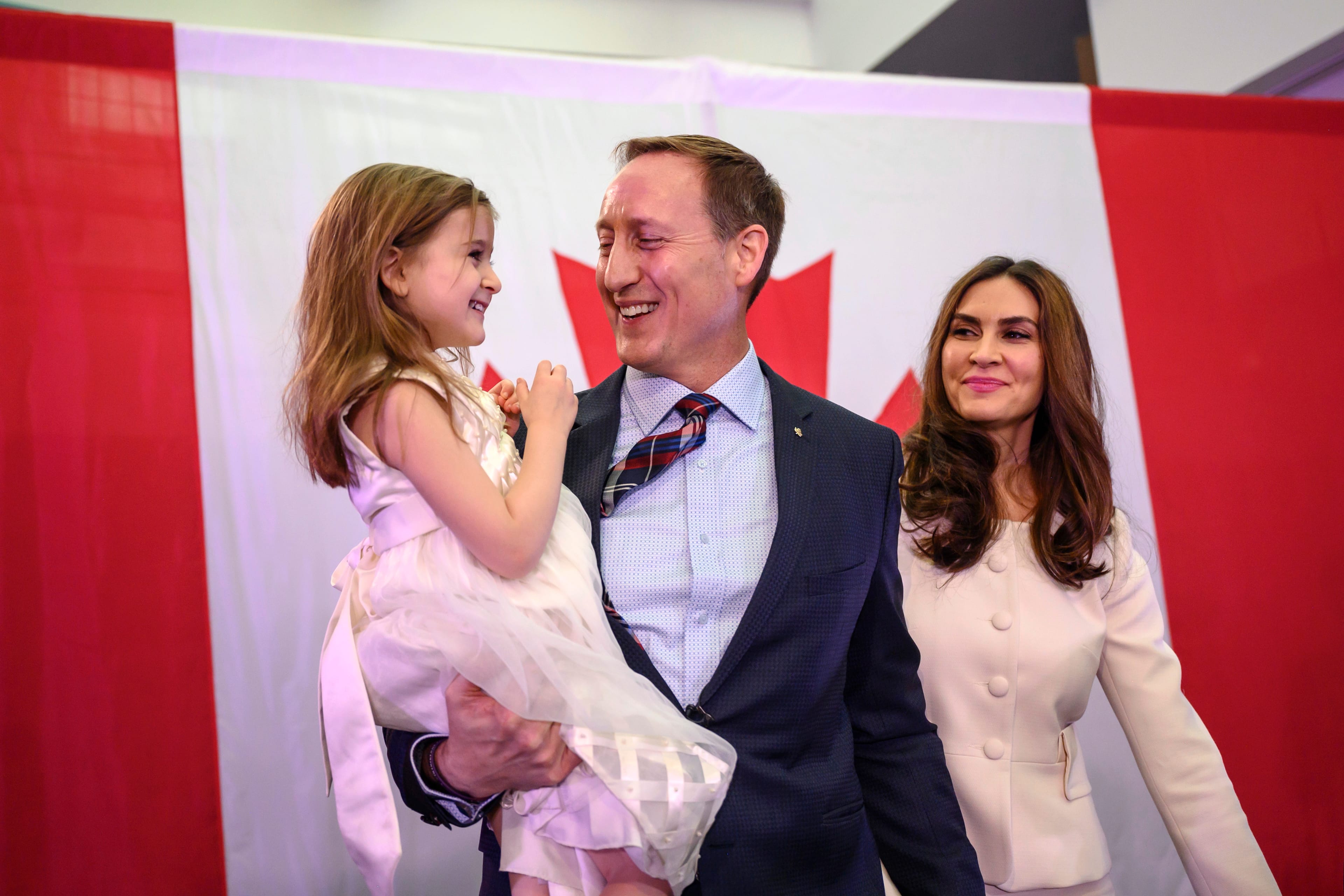 Peter MacKay holds his daughter Valentia MacKay as his wife, Nazanin Afshin-Jam, looks on following MacKay's official campaign launch for leader of the Conservative Party of Canada in Stellarton, N.S. on Jan. 25.(Darren Calabrese/CP)
