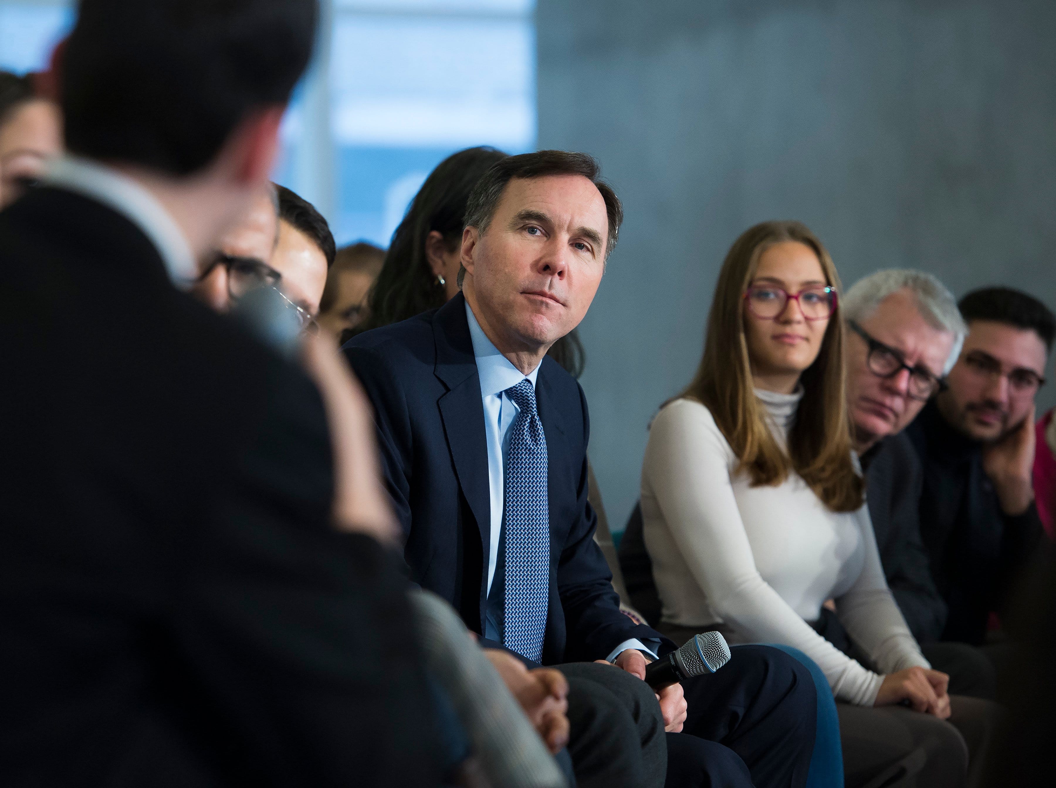 Finance Minister Bill Morneau, centre, listens to a question from a Ryerson University student as he launches consultations for the Budget 2020 at a town hall discussion in Toronto on Jan. 13. (Nathan Denette/CP)