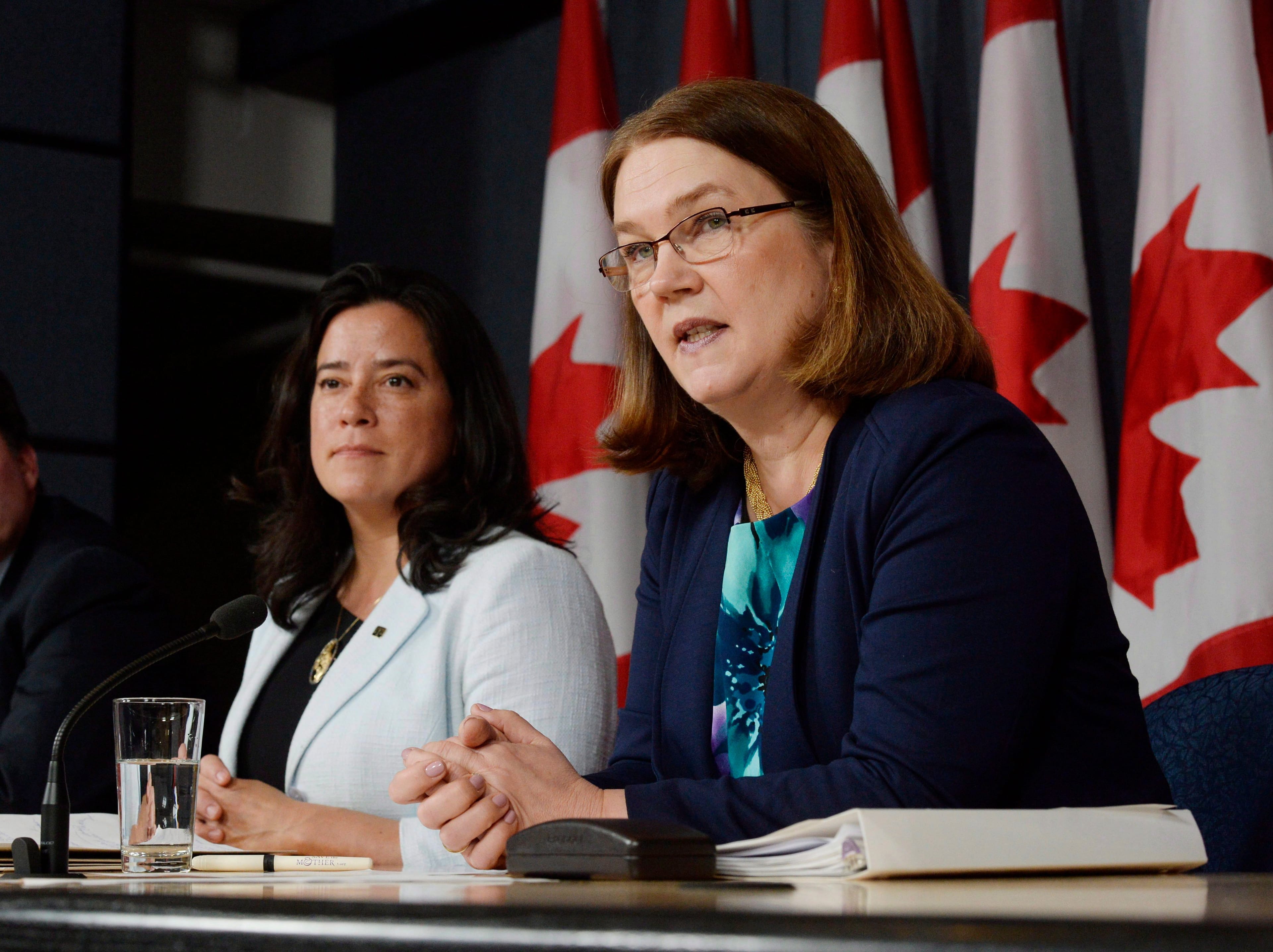 Previous Health Minister Jane Philpott, right, speaks as previous Justice Minister Jody Wilson-Raybould looks on at a news conference in Ottawa on Apr. 14, 2016. The federal government introduced a long-awaited and controversial new law spelling out the conditions in which seriously ill or dying Canadians may seek medical help to end their lives.The legislation says there should be a choice of medically assisted death "for adults who are suffering intolerably and for whom death is reasonably foreseeable." (Adrian Wyld/CP)
