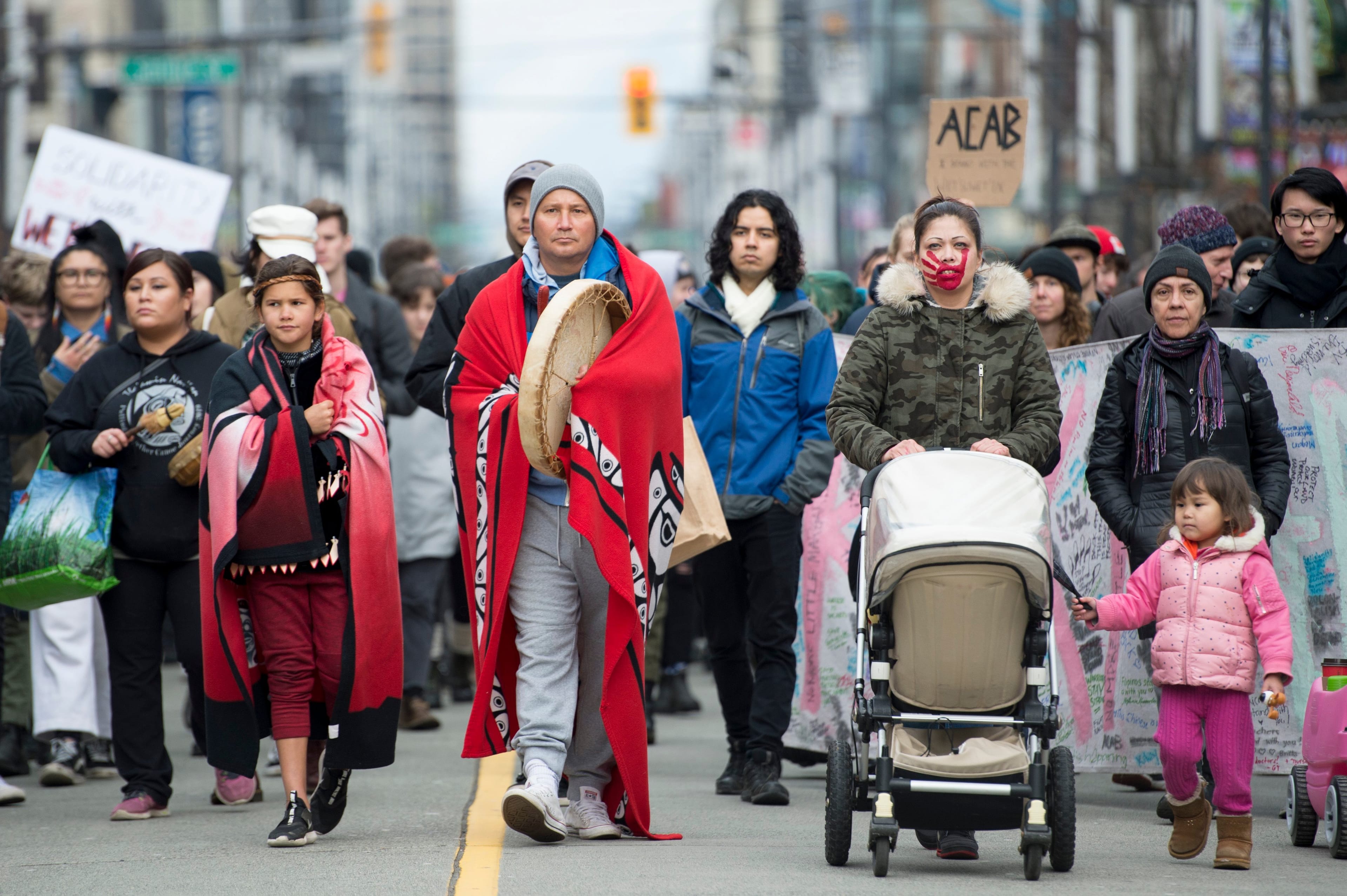 Protesters walk down Granville Street in downtown Vancouver on Feb. 12, 2020. The protesters are standing in solidarity with the Wet'suwet'en hereditary chiefs opposed to the LNG pipeline in northern British Columbia. (Jonathan Hayward/CP)