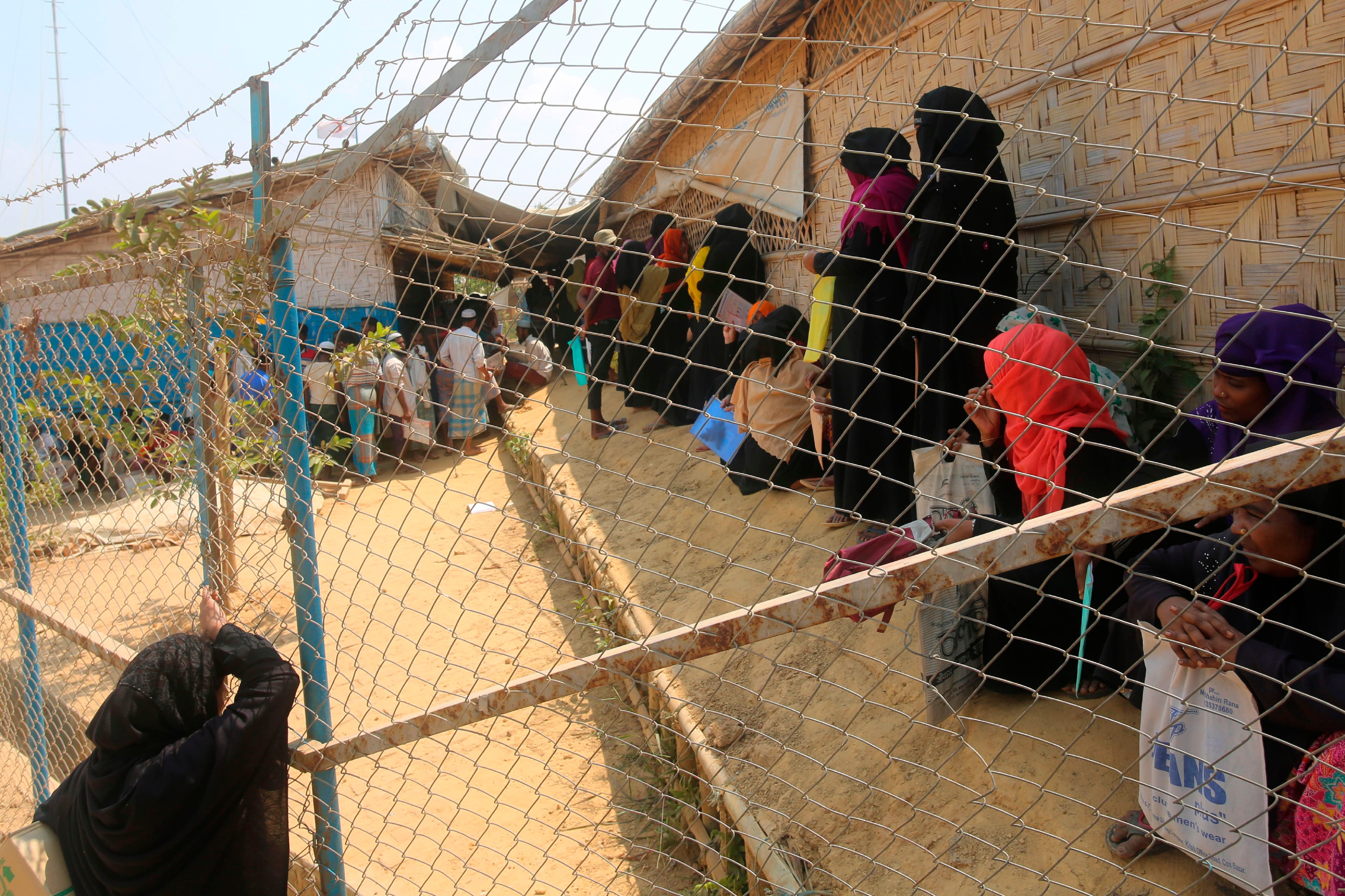 Rohingya refugees wait in a relief distribution point at Kutupalong refugee camp in Ukhia March 24, 2020. (Photo by SUZAUDDIN RUBEL / AFP) (Photo by SUZAUDDIN RUBEL/AFP via Getty Images)