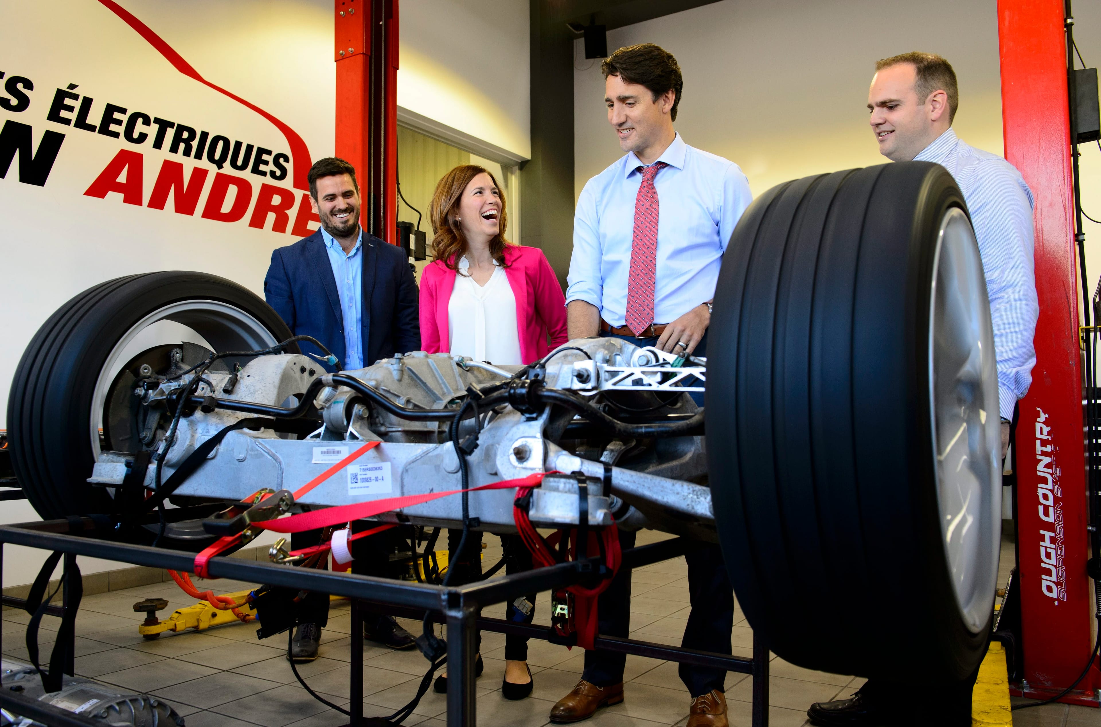 Justin Trudeau is given a demonstration of an electric car motor as he makes a campaign stop at an electric vehicle car dealership in Trois-Rivieres, Que., on Friday, Sept. 13, 2019. (Sean Kilpatrick/CP)