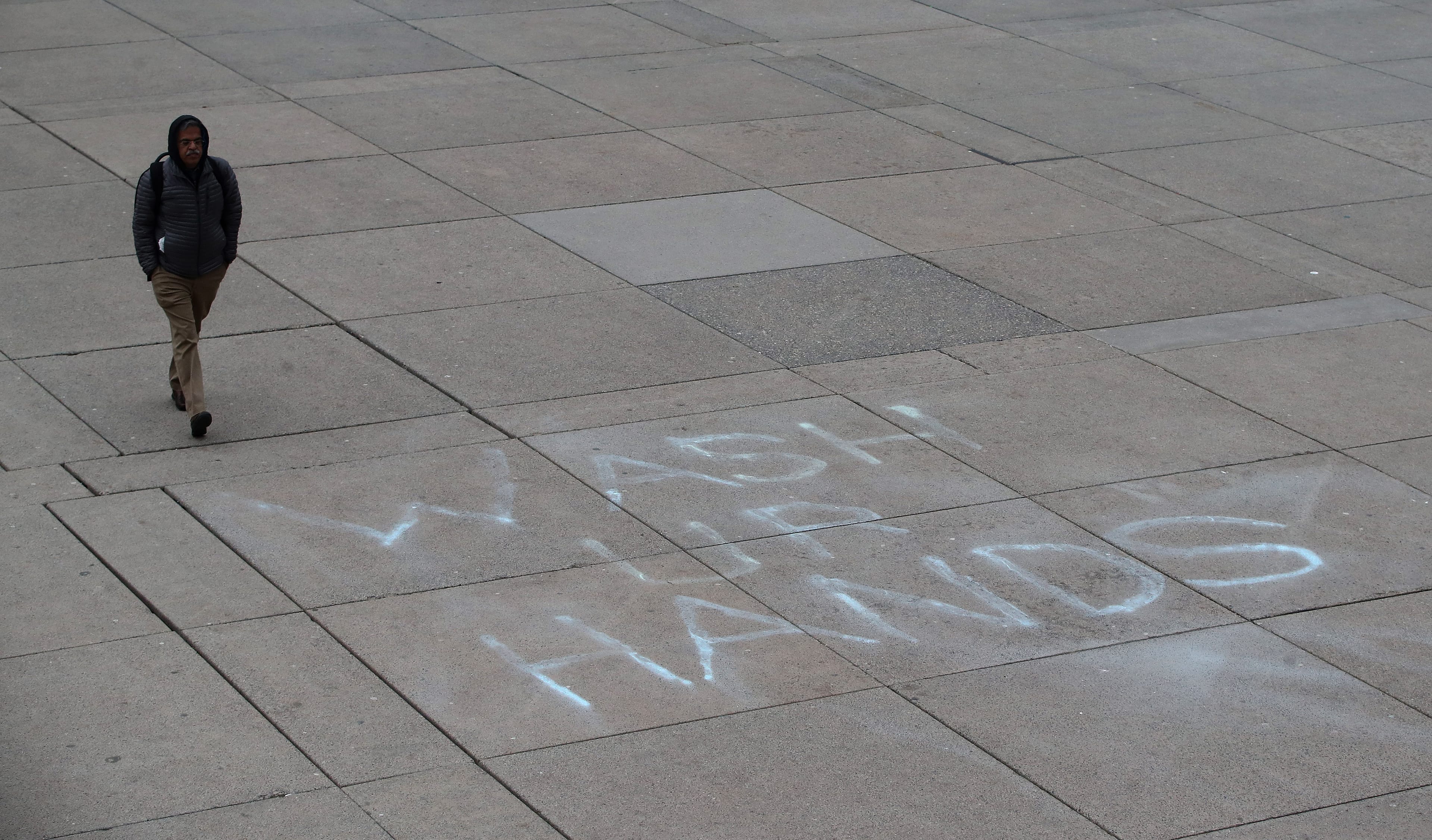 A person walks through Nathan Phillips Square at Toronto City Hall on March 19, 2020 (Steve Russell/Toronto Star via Getty Images)
