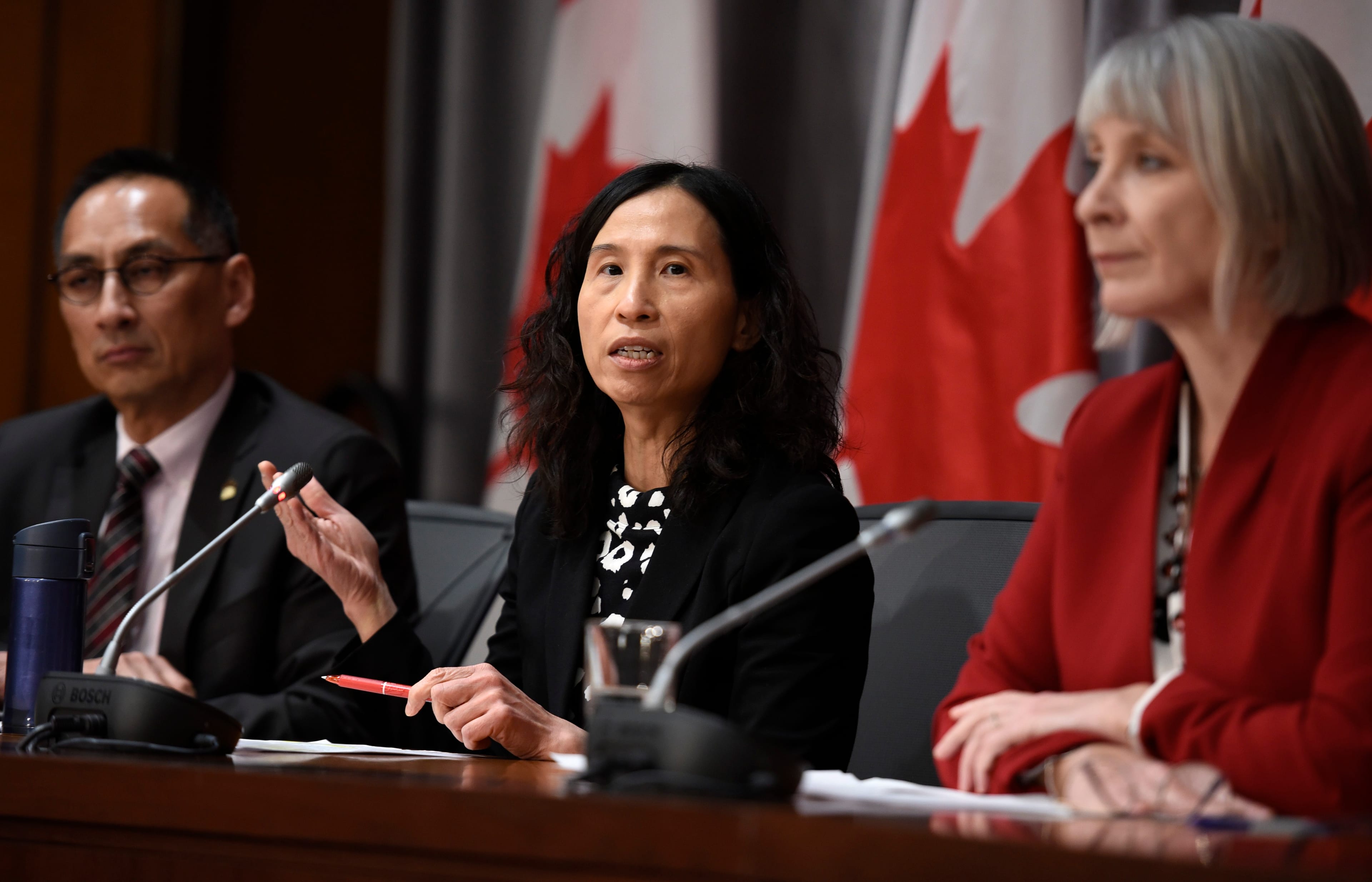 Chief Public Health Officer of Canada Dr. Theresa Tam speaks as Minister of Health Patty Hadju, right, and Deputy Chief Public Health Officer Dr. Howard Njoo listen during a press conference on COVID-19 in West Block on Parliament Hill in Ottawa, on Thursday, March 19, 2020. (Justin Tang/CP)