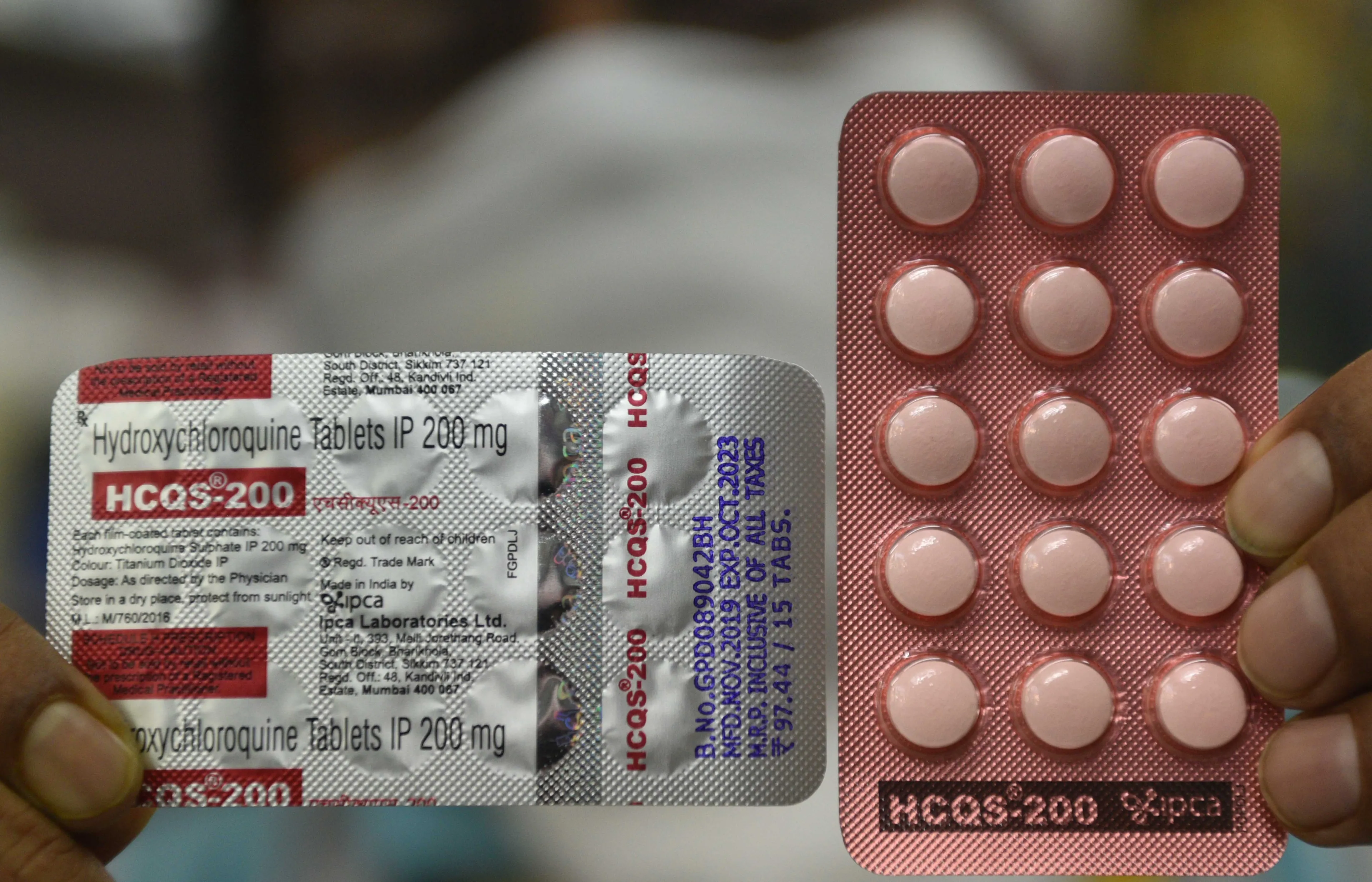 A drugstore employee in Kolkata, India holds a strip of hydroxychloroquine on day eight of the country's nationwide lockdown (Samir Jana/Hindustan Times via Getty Images)