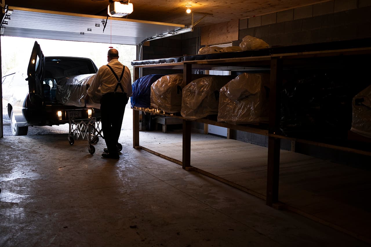 04/10/20 - Funeral Director RIchard Paul unloads a casket at the winter vault in Powassan, Ontario.