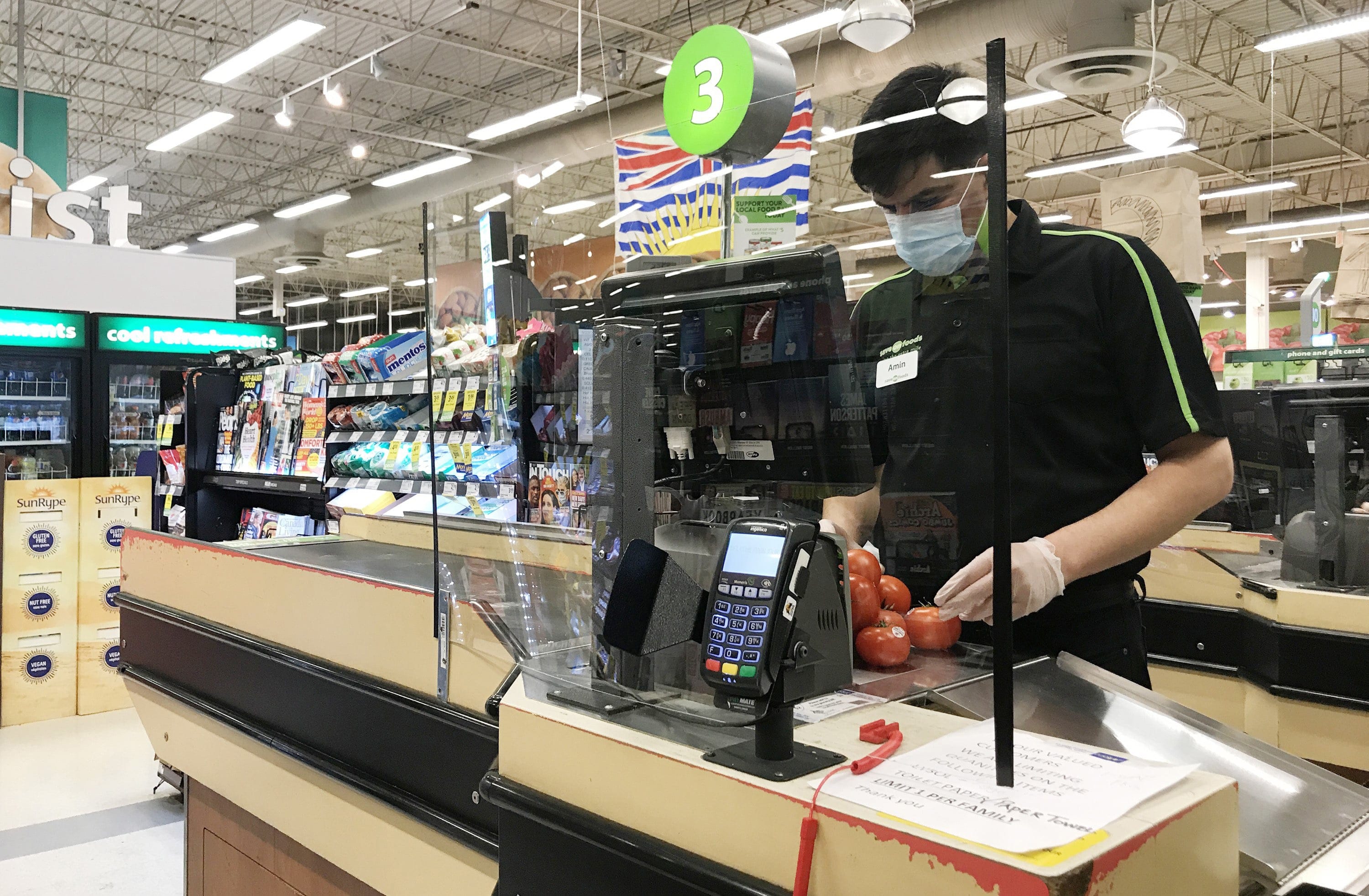 A plexiglass barrier is pictured creating a barrier to protect a cashier at a grocery store in North Vancouver, B.C. Sunday, March 22, 2020. (Jonathan Hayward/CP)