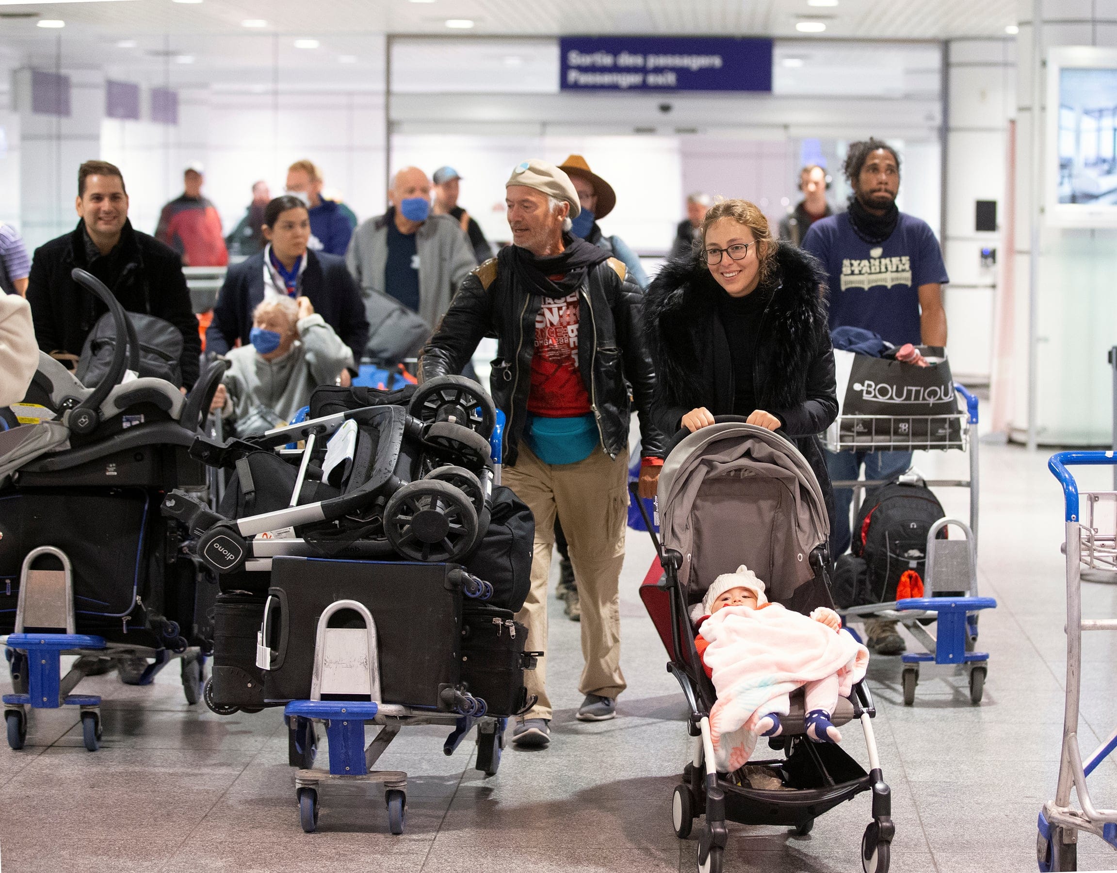 Relieved Canadians arrive in Montreal on March 23 after being stranded in Morocco (Christinne Muschi/Reuters)
