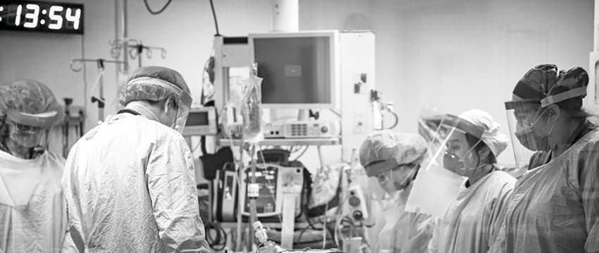(From left to right) emergency doctors Layli Sanaee and Derrick Chang, respiratory therapist Mooska Mayel, and emergency nurses Dalena Dang and Ashley Mitchell pause for a moment of respect after a patient dies despite a prolonged resuscitation. (Dawn Lim)