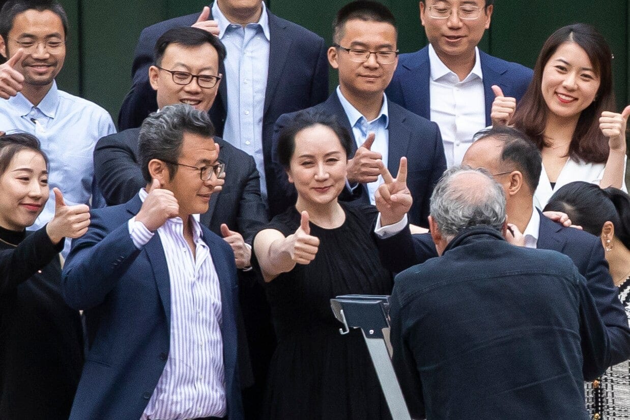 Meng Wanzhou poses with friends and family on the steps of the Supreme Court building in Vancouver. (Ben Nelms/CBC)