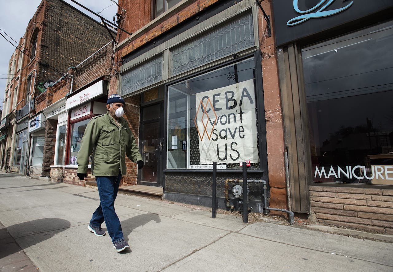 A closed store front boutique business pleads for help, displaying a sign in Toronto on April 16, 2020 (Nathan Denette/CP)