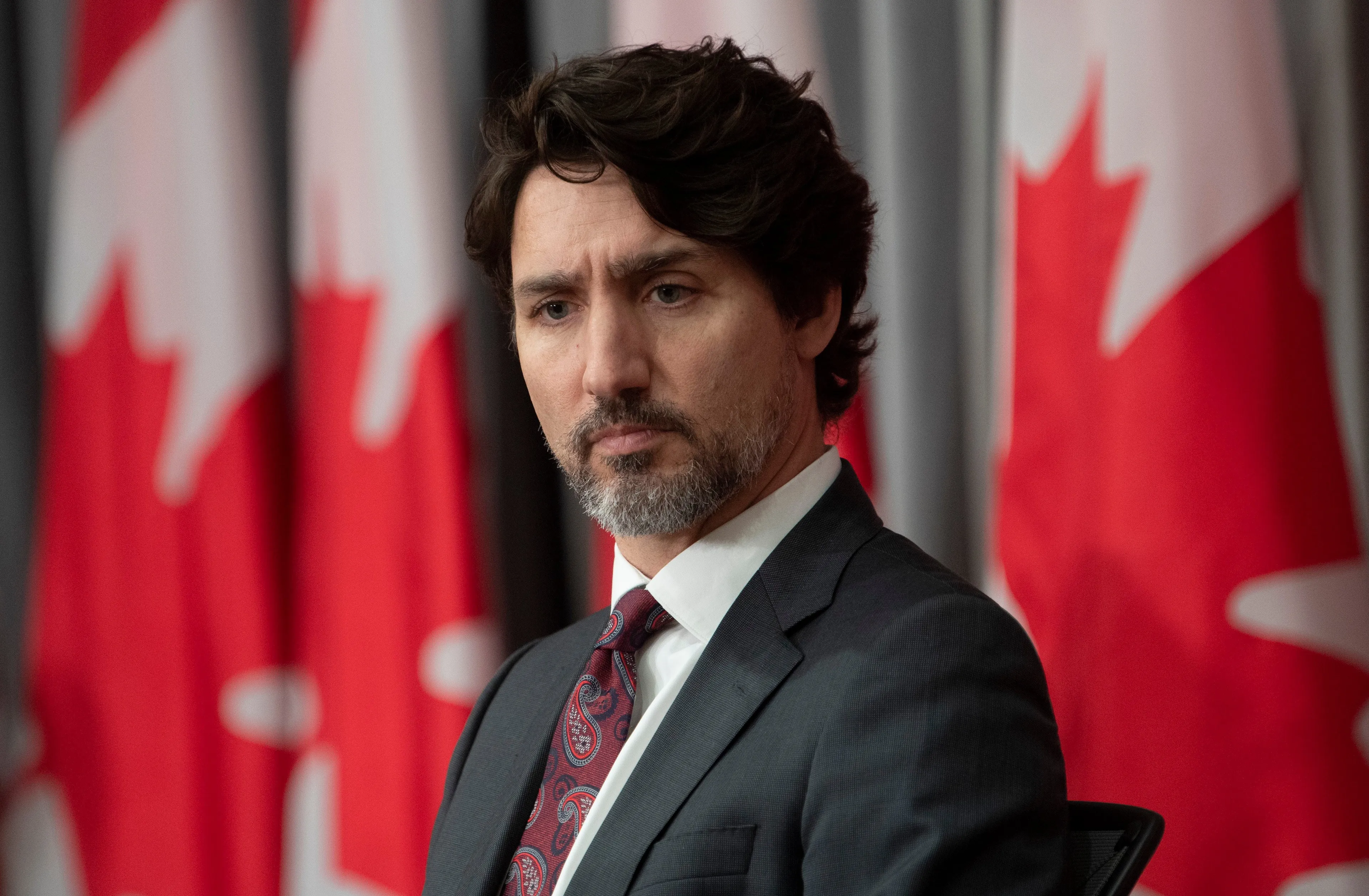 Prime Minister Justin Trudeau listens as a speaker lists Canadian mass shootings during an announcement in Ottawa, Friday May 1, 2020. THE CANADIAN PRESS/Adrian Wyld