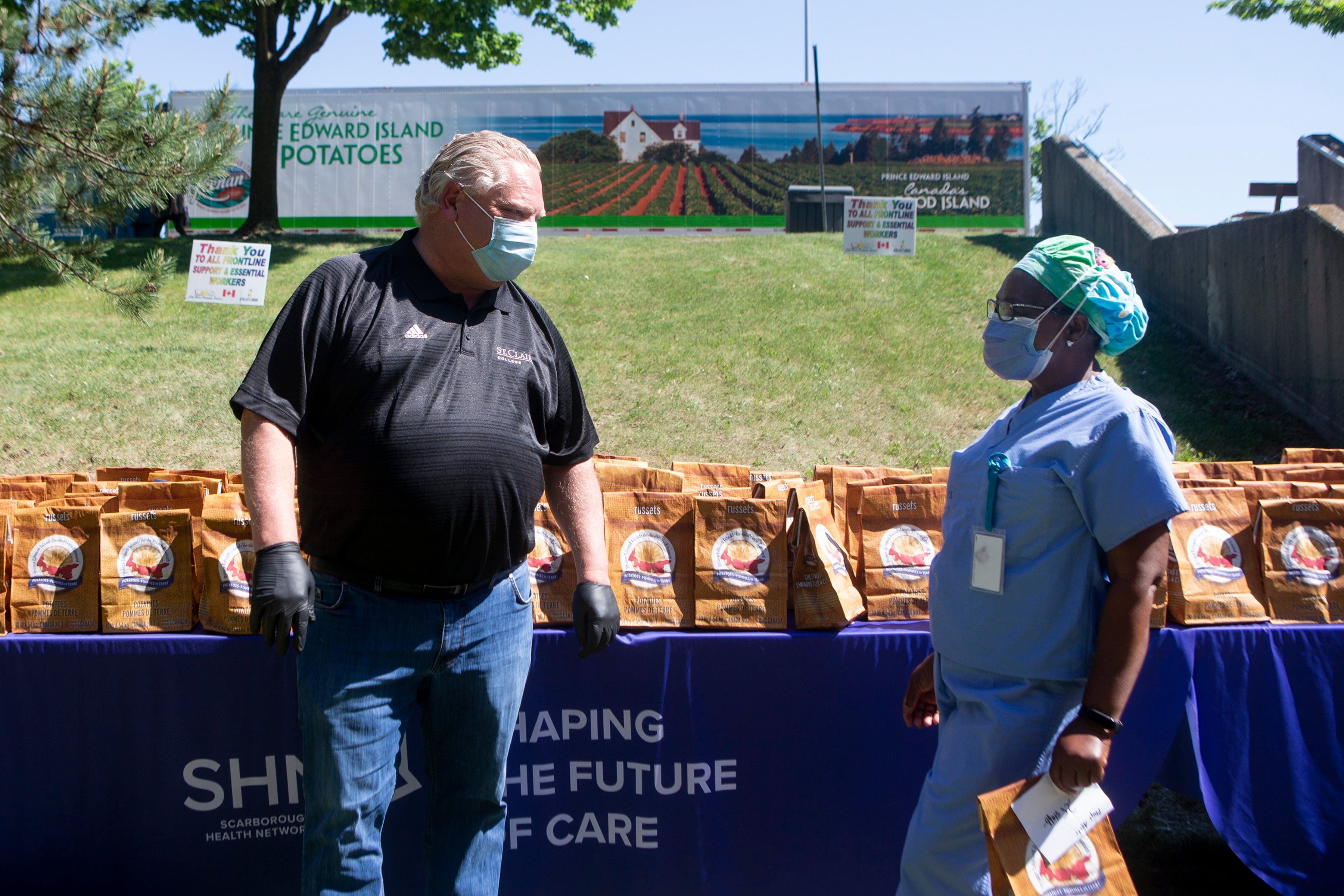 Ford hands out bagged gifts from Prince Edward Island for health workers at Birchmount Hospital in Toronto on June 8, 2020 (Chris Young/CP)