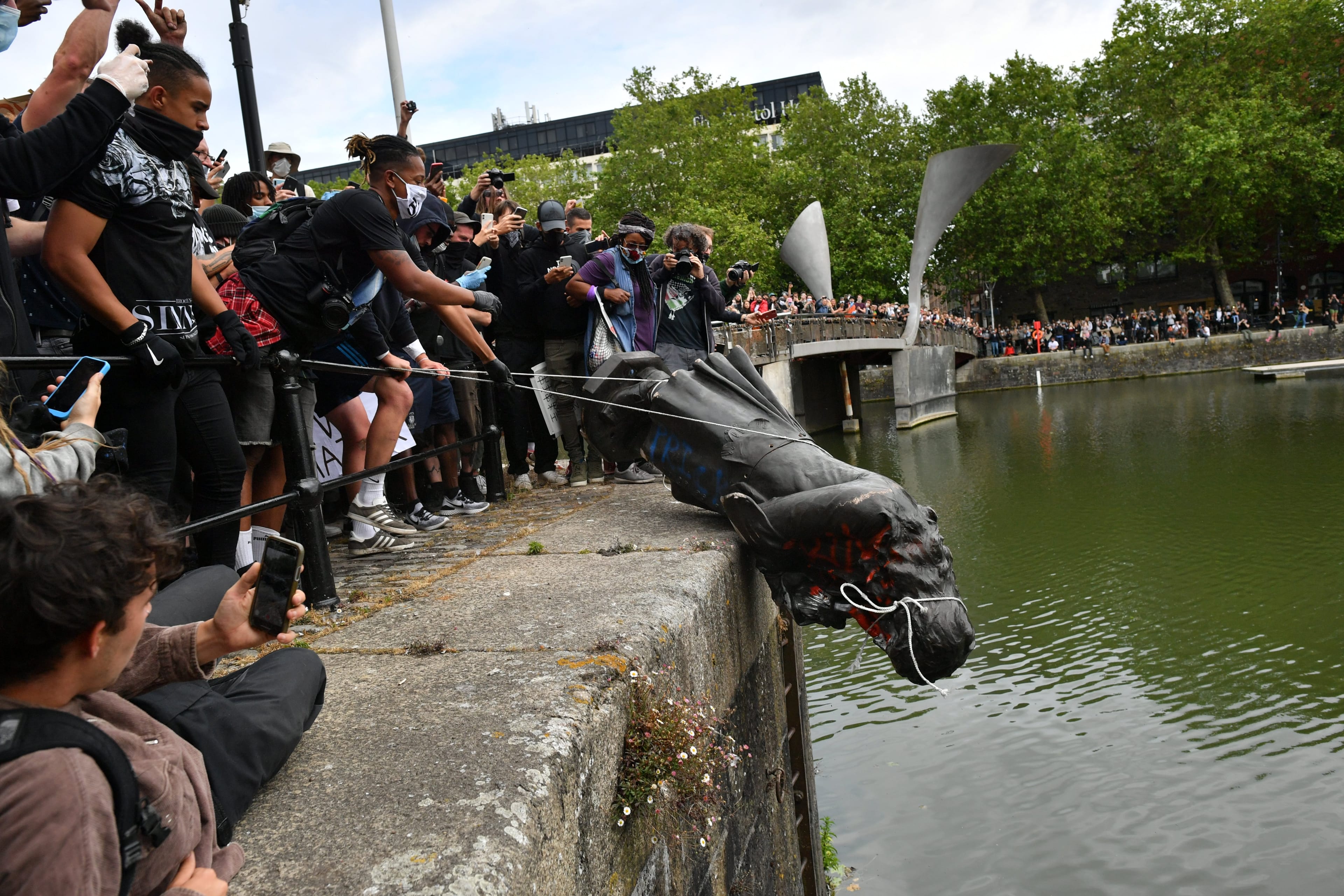 Protesters throw a statue of Edward Colston into Bristol harbour during a Black Lives Matter protest rally (Ben Birchall/PA Images via Getty Images)