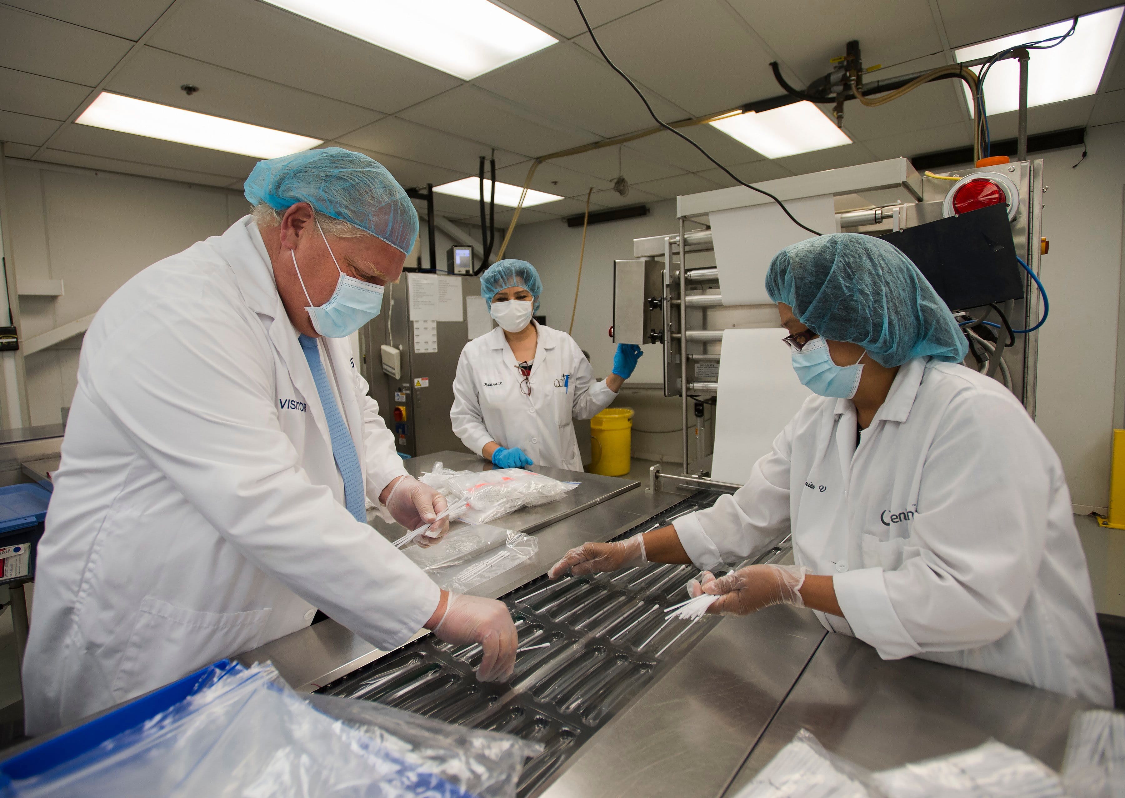 Ontario Premier Doug Ford visits Canadian Hospital Specialities (CHS) helping them take dual COVID-19 testing swab kits and separating them into two units to help with swab capacity during the COVID-19 pandemic in Oakville, Ont. on Jun. 8, 2020. (Nathan Denette/CP)