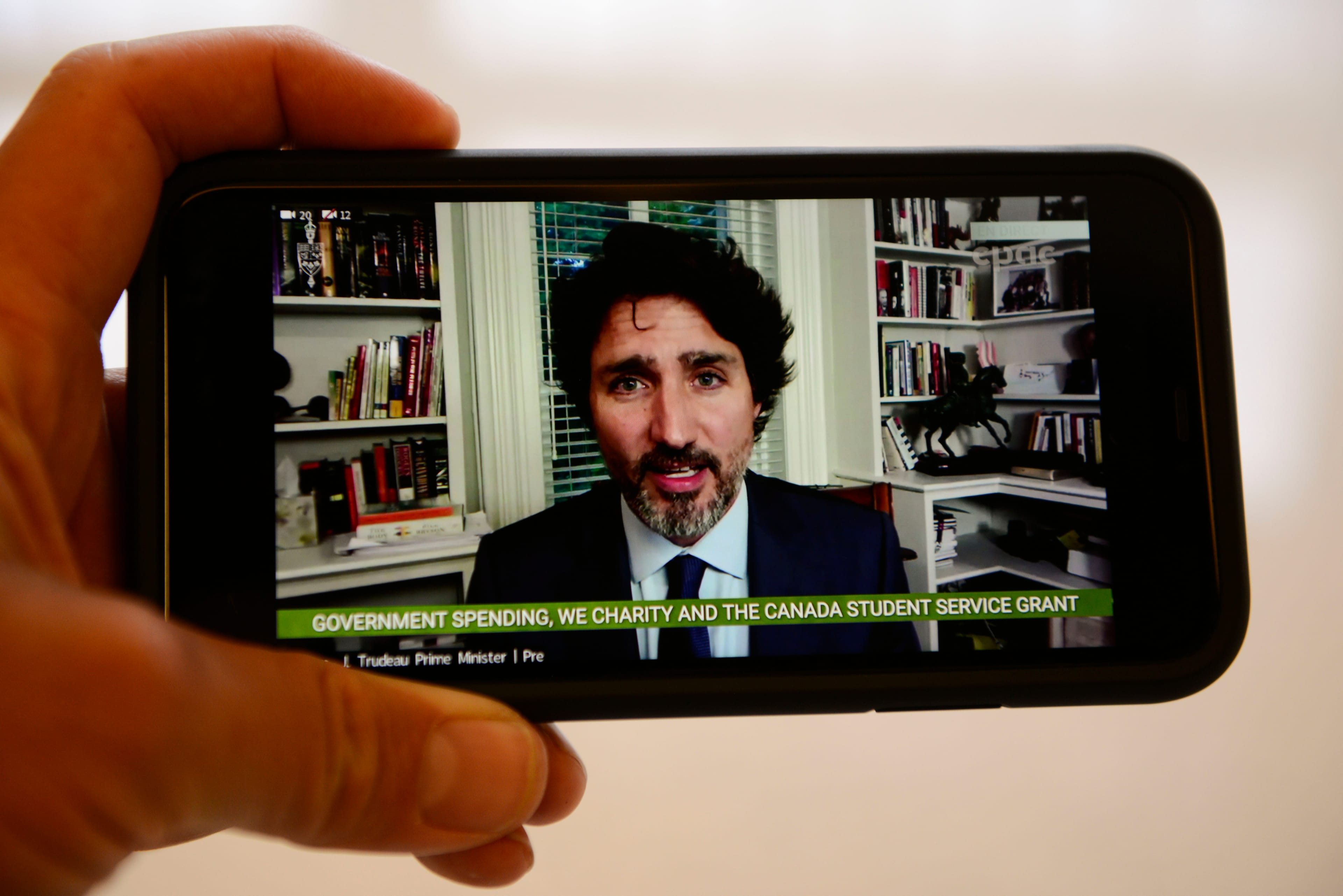 Prime Minister Justin Trudeau is viewed on a mobile phone as he appears as a witness via videoconference during a House of Commons finance committee in the Wellington Building on July 30, 2020.(Sean Kilpatrick/CP)