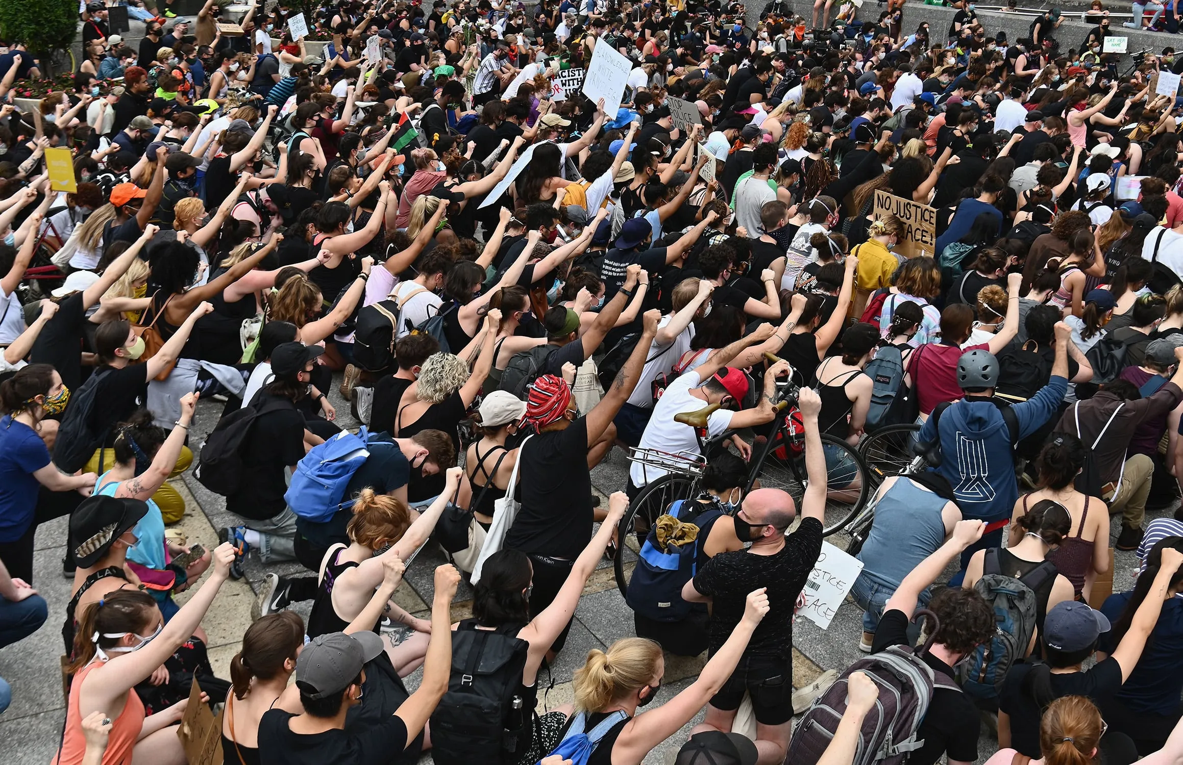 Protesters kneel and raise their fists during a Black Lives Matter demonstration in Brooklyn, N.Y. (Angela Weiss/AFP/Getty Images)