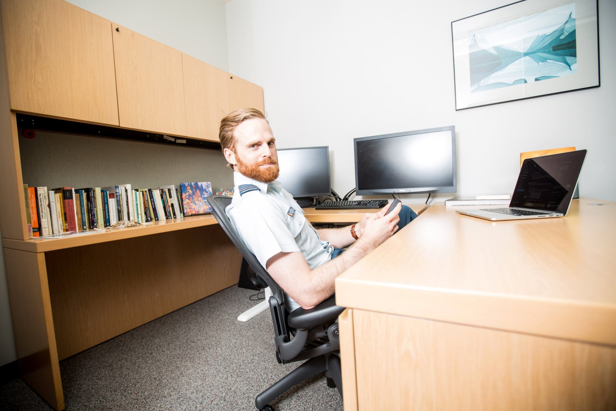 Captain Kirk Sullivan reviews tweets in his office in the Canadian Embassy in Washington, DC. (Photograph by Farrah Skeiky)