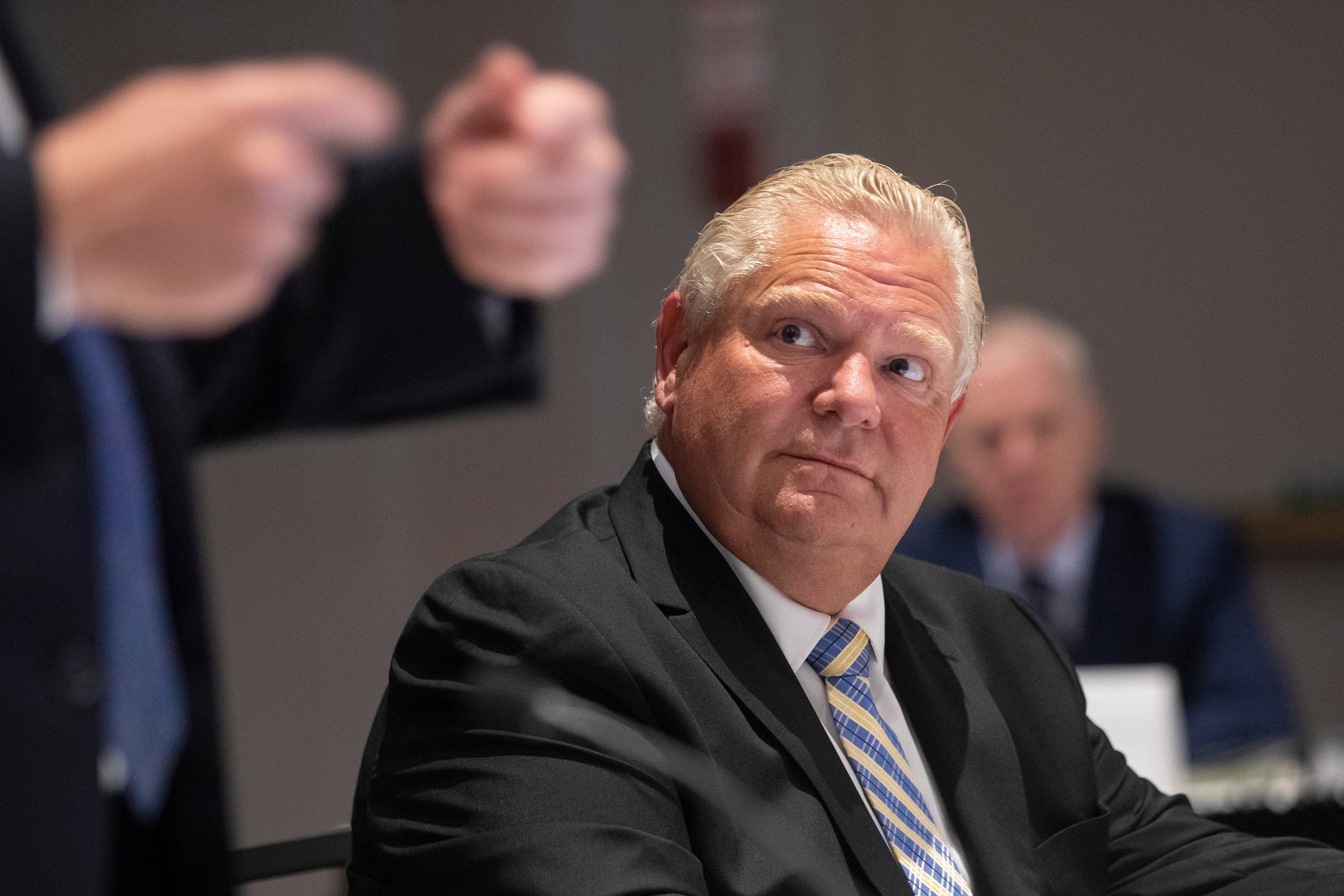 Ontario Premier Doug Ford listens as Quebec Premier Francois Legault addresses the media as they attend the Ontario-Quebec Summit, in Toronto, on Wednesday, September 9, 2020. THE CANADIAN PRESS/Chris Young