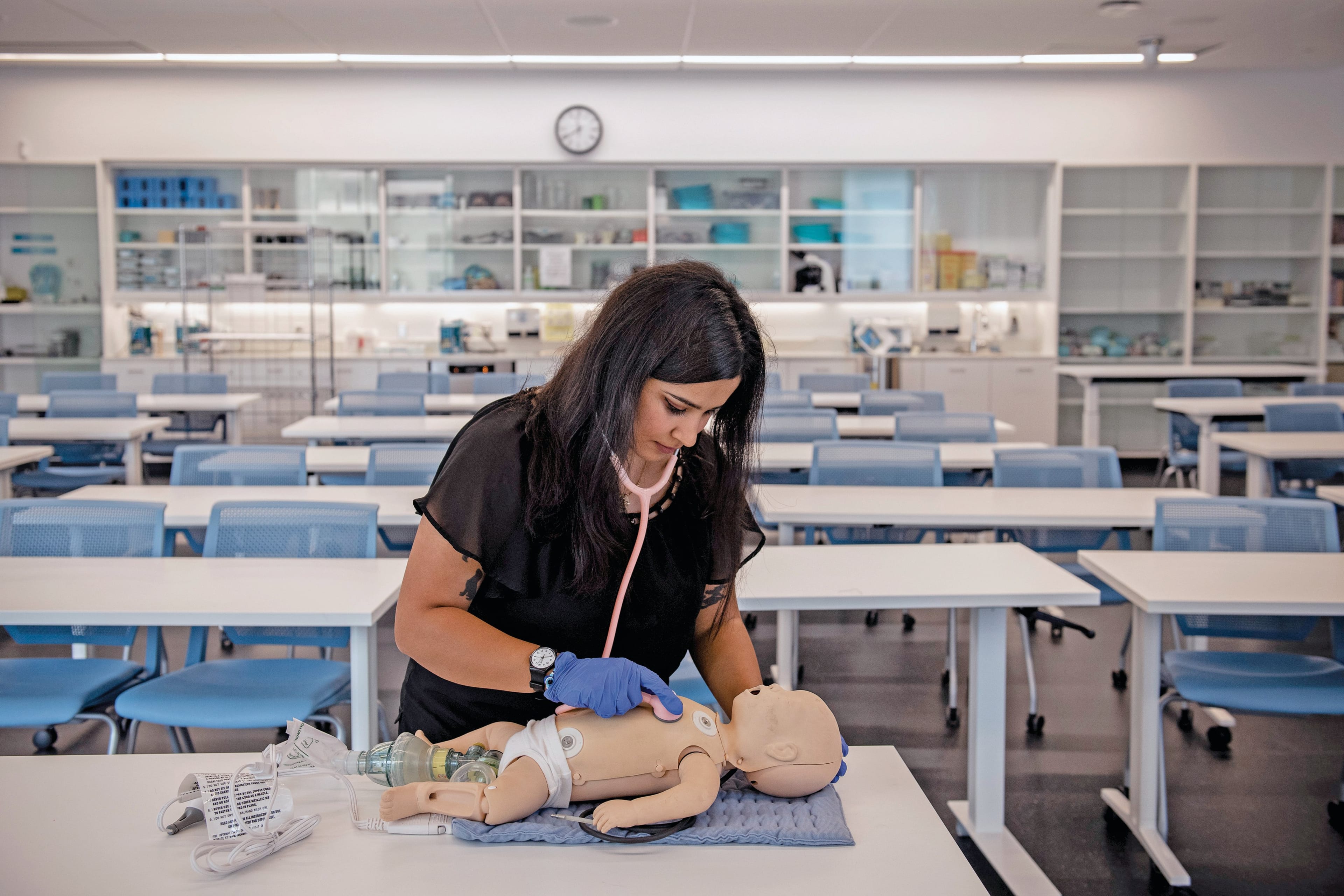 Maryam performs a mock checkup on a doll (Photograph by Kiana Hayeri)
