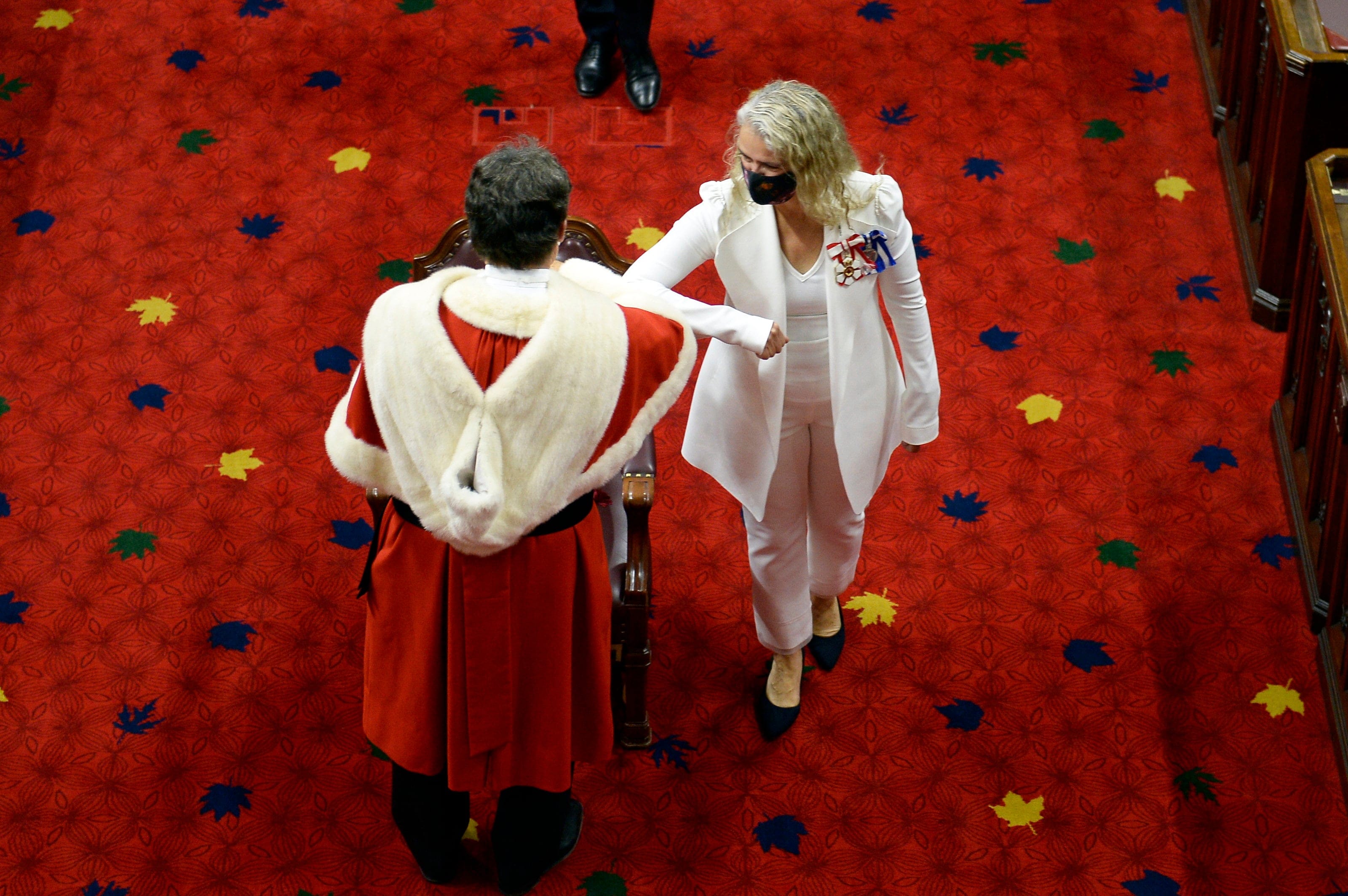Gov. Gen. Julie Payette bumps elbows with Chief Justice Richard Wagner as she arrives for the throne speech in the Senate chamber in Ottawa, Ontario, Wednesday, Sept.23, 2020. (Justin Tang/CP)