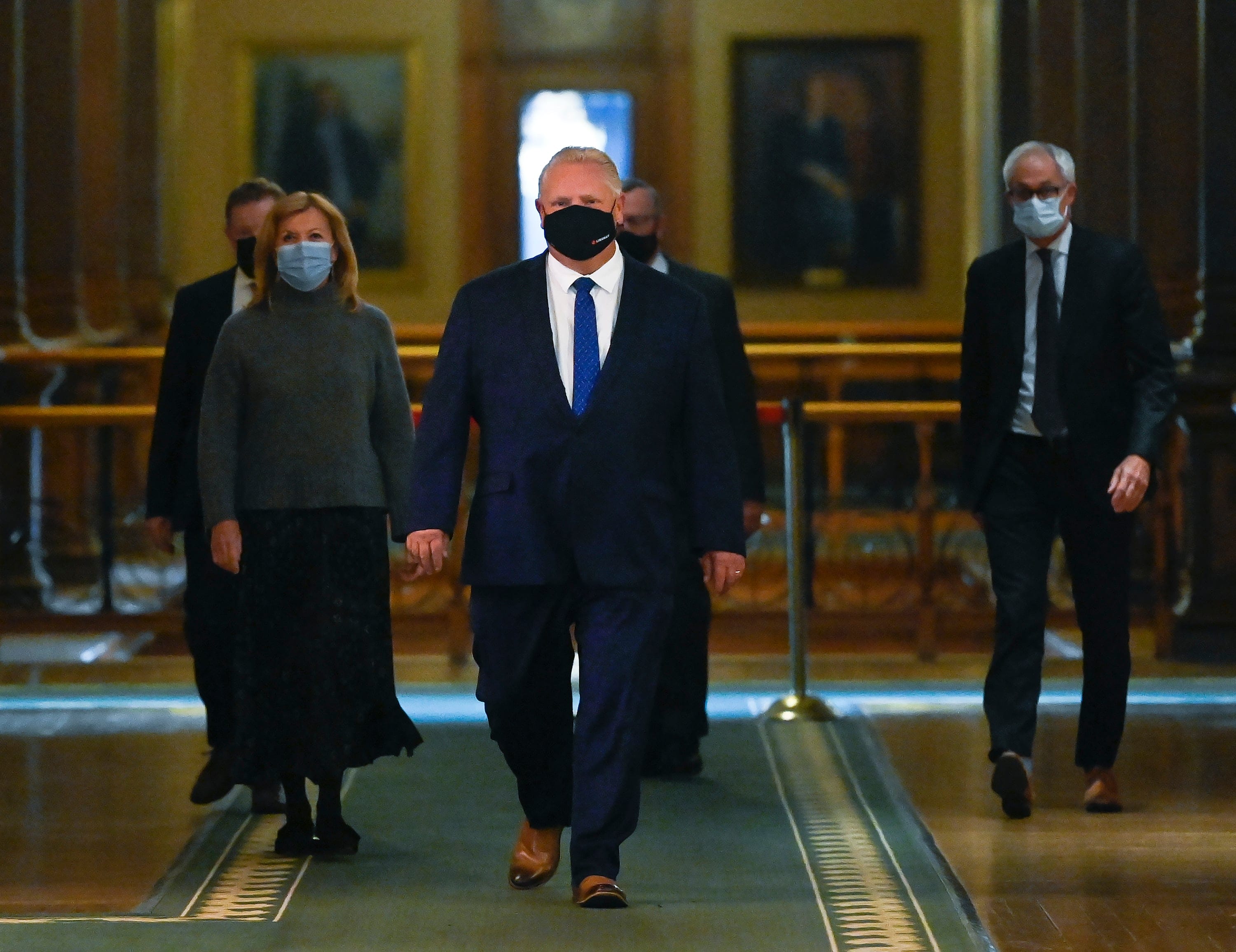 Ontario Premier Doug Ford, centre, walks to a press conference regarding new restrictions at Queen's Park during the COVID-19 pandemic in Toronto on Friday, October 2, 2020. THE CANADIAN PRESS/Nathan Denette