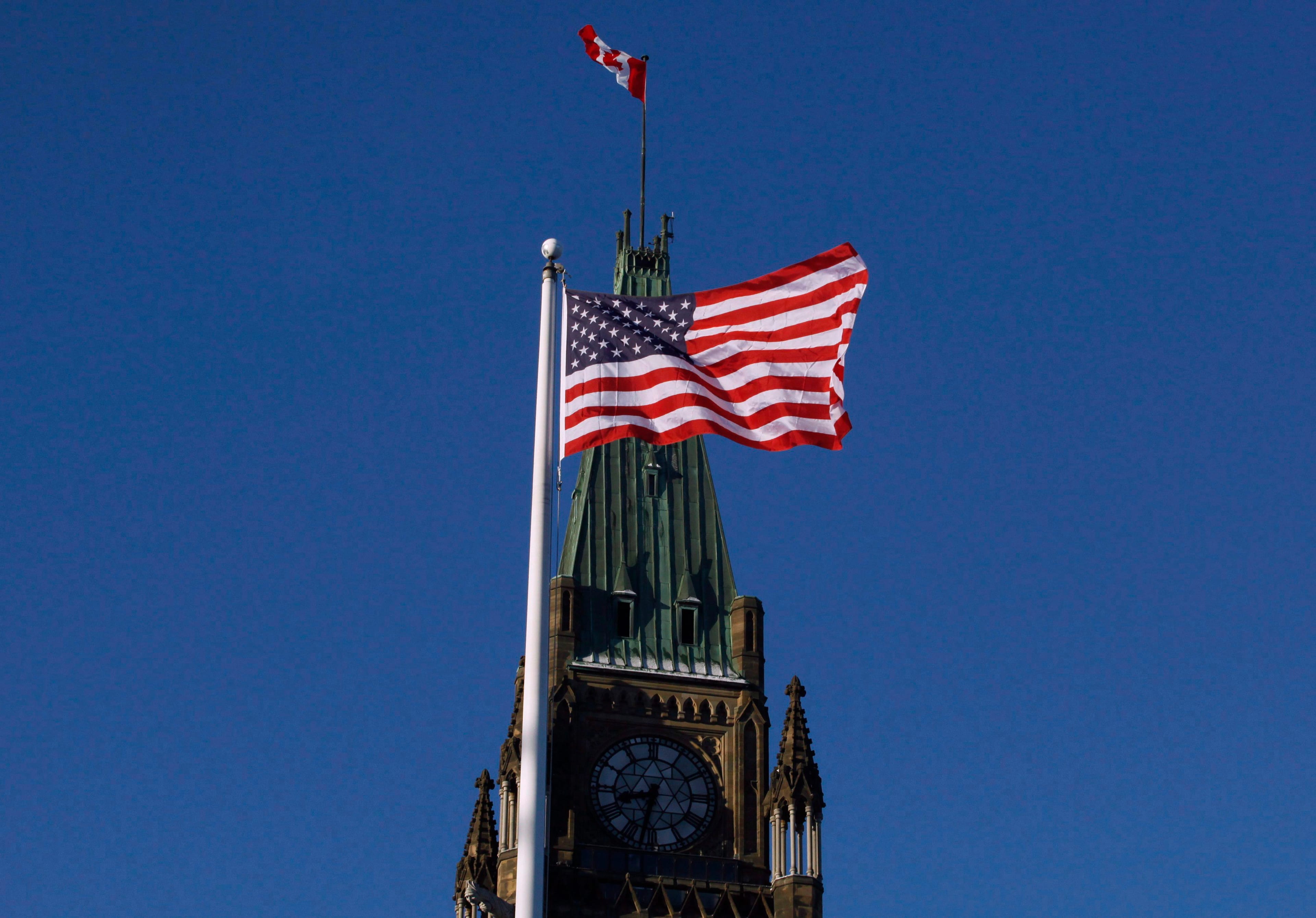 The American flag flies in front of the Peace Tower on Parliament Hill before the arrival of US Vice President Joe Biden in Ottawa on Friday, Dec. 9, 2016. (Patrick Doyle/CP)