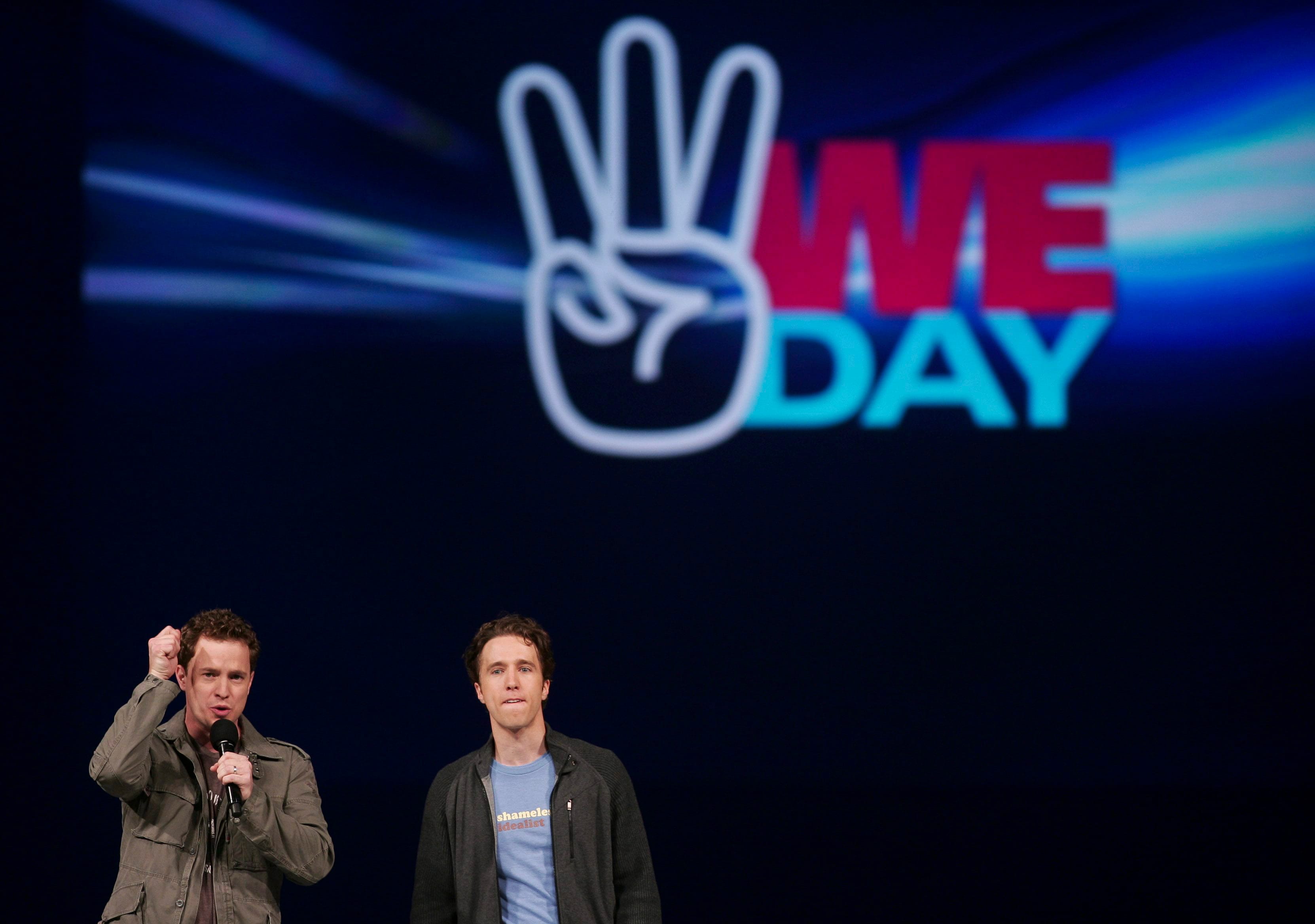Marc and Craig Kielburger speak at the WE Day celebrations in Kitchener, Ont., on Feb. 17, 2011 (CP/Geoff Robins)