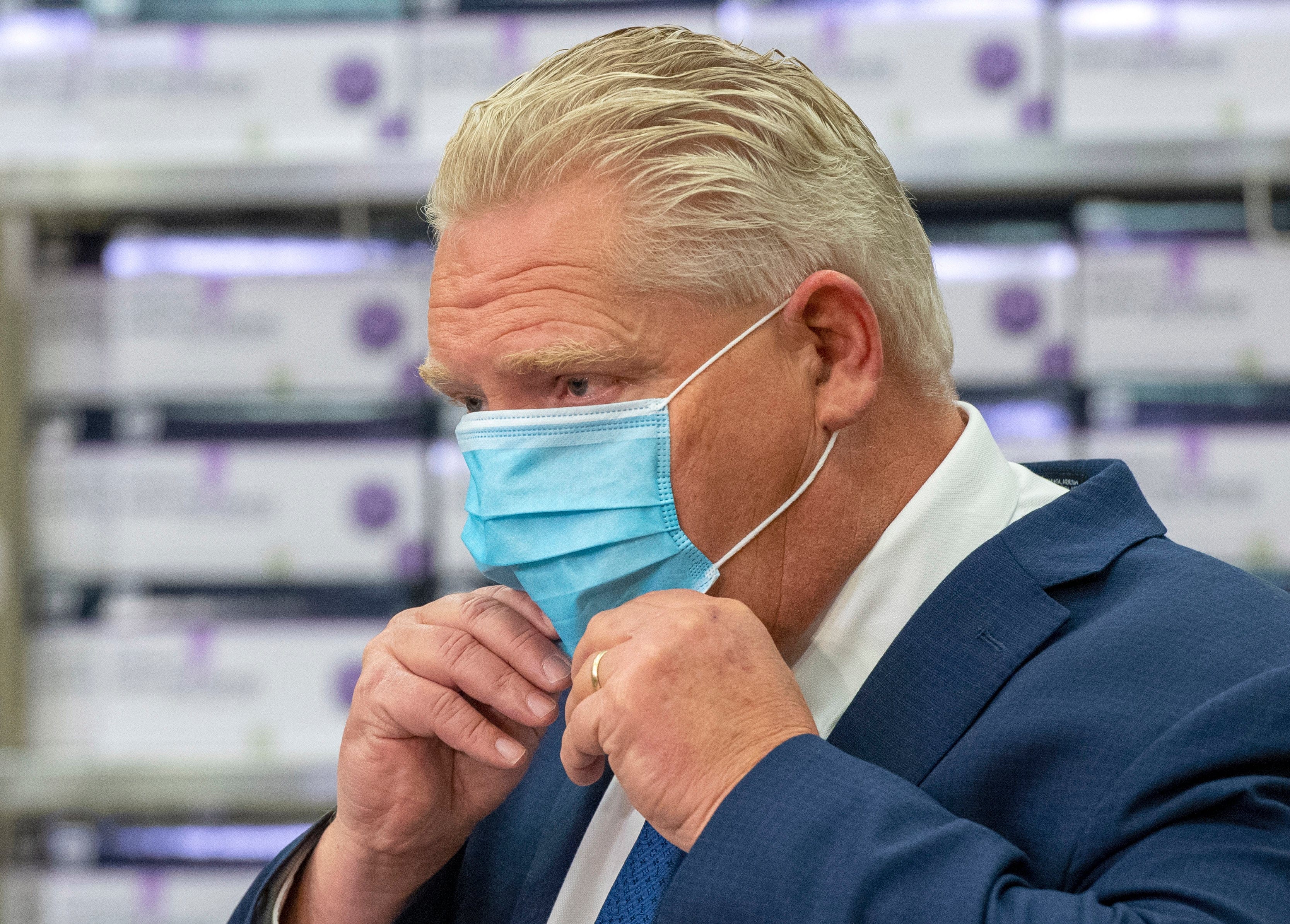Ontario Premier Doug Ford puts his mask back on during the daily briefing at Humber River Hospital in Toronto on Tuesday November 24, 2020. THE CANADIAN PRESS/Frank Gunn