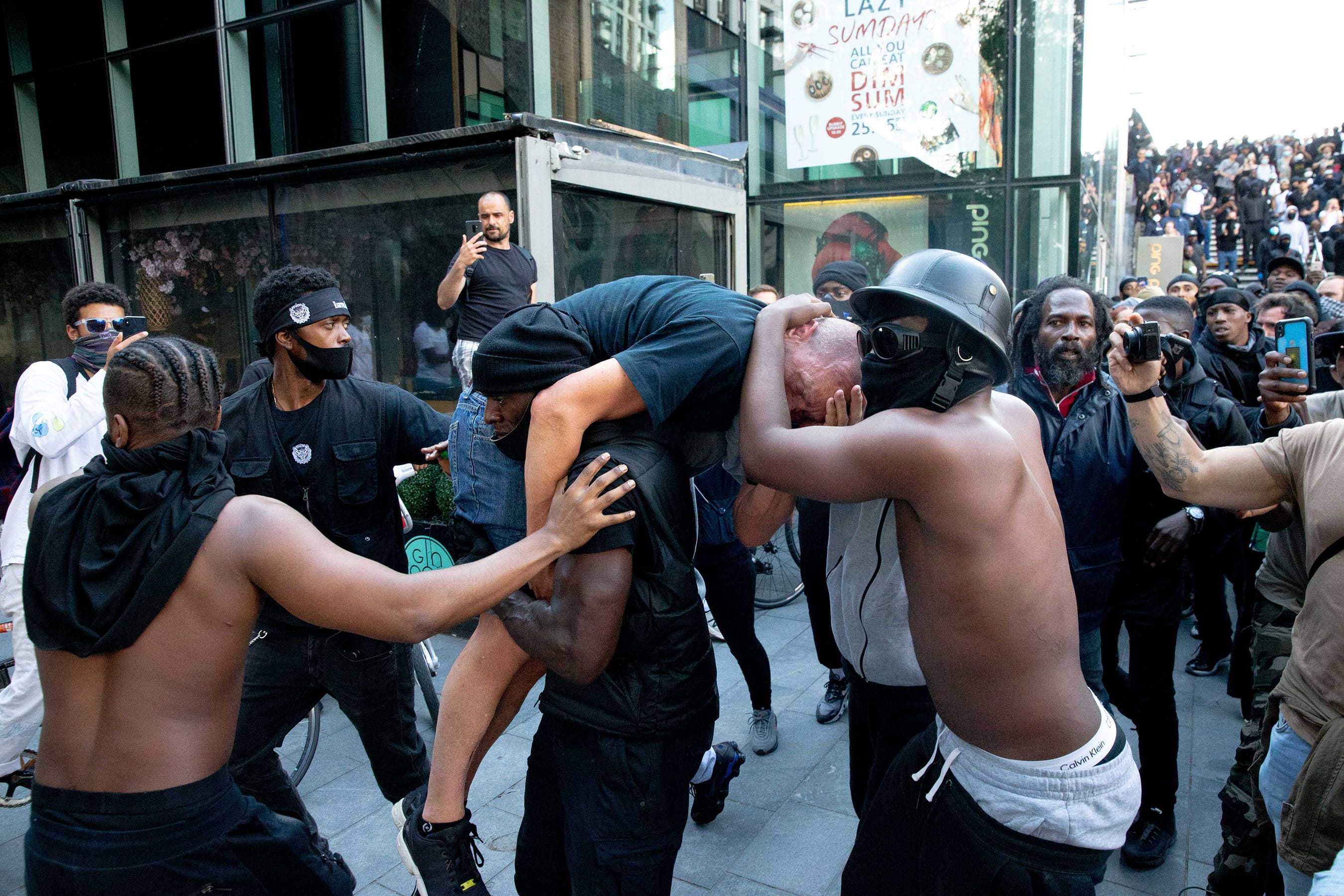 A group of protesters protect an injured man, taking him to safety during a U.K. protest (Luke Dray/Getty Images)