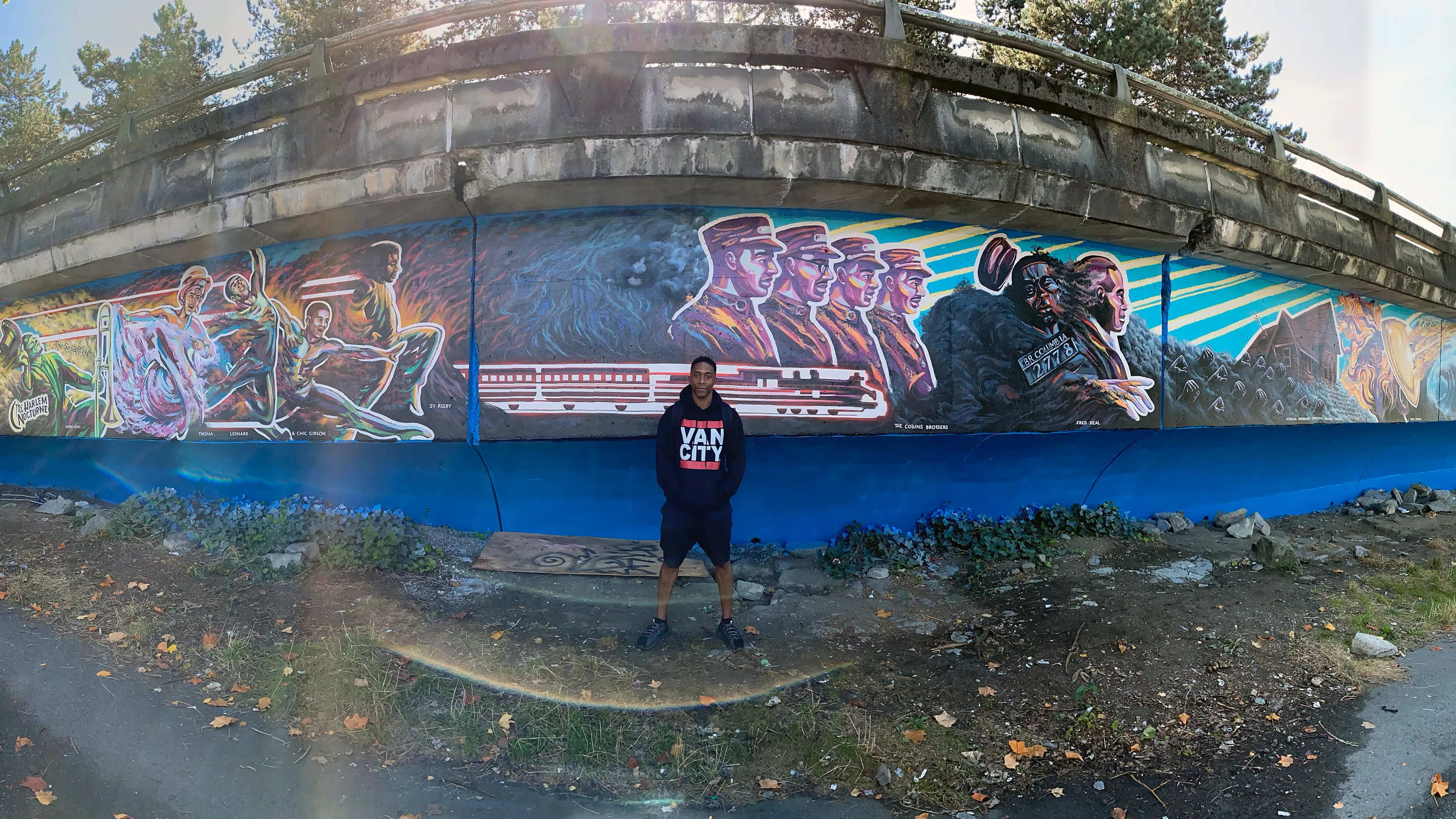 Joseph in front of his mural, 'Hope Through Ashes: A Requiem for Hogan’s Alley' (Rochelle Leung)