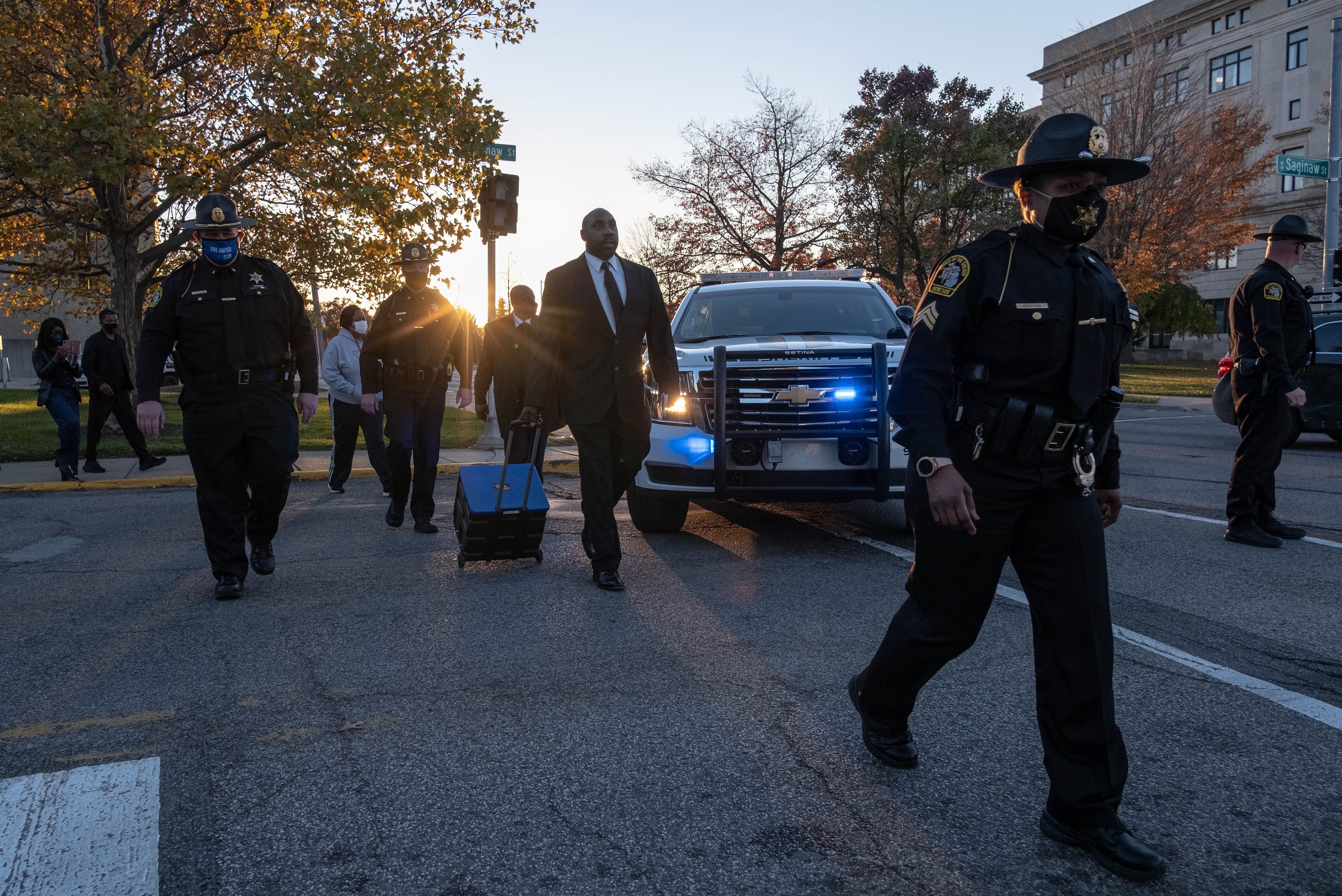 Officers from the sheriff's department in Flint, Mich. take absentee ballots filled out by people in pretrial custody for counting on Tuesday—just some of the votes being tallied that could determine the outcome of the U.S. election. (Seth Herald/AFP/Getty Images)
