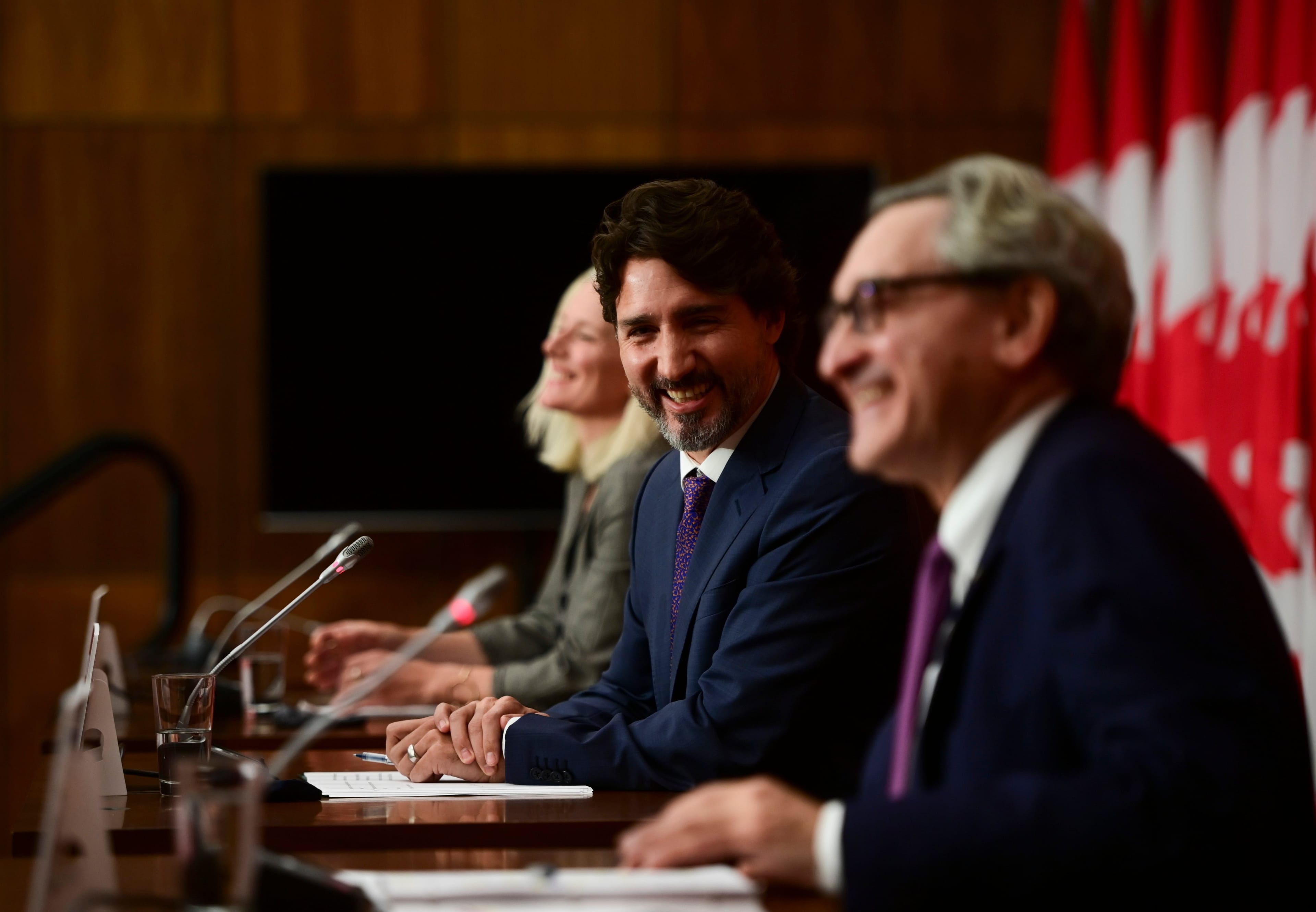 Minister of Infrastructure Catherine McKenna, Trudeau, and Sabia, then chair of the Canada Infrastructure Bank, share a laugh as they hold a press conference in Ottawa on Oct. 1, 2020 (CP/Sean Kilpatrick)