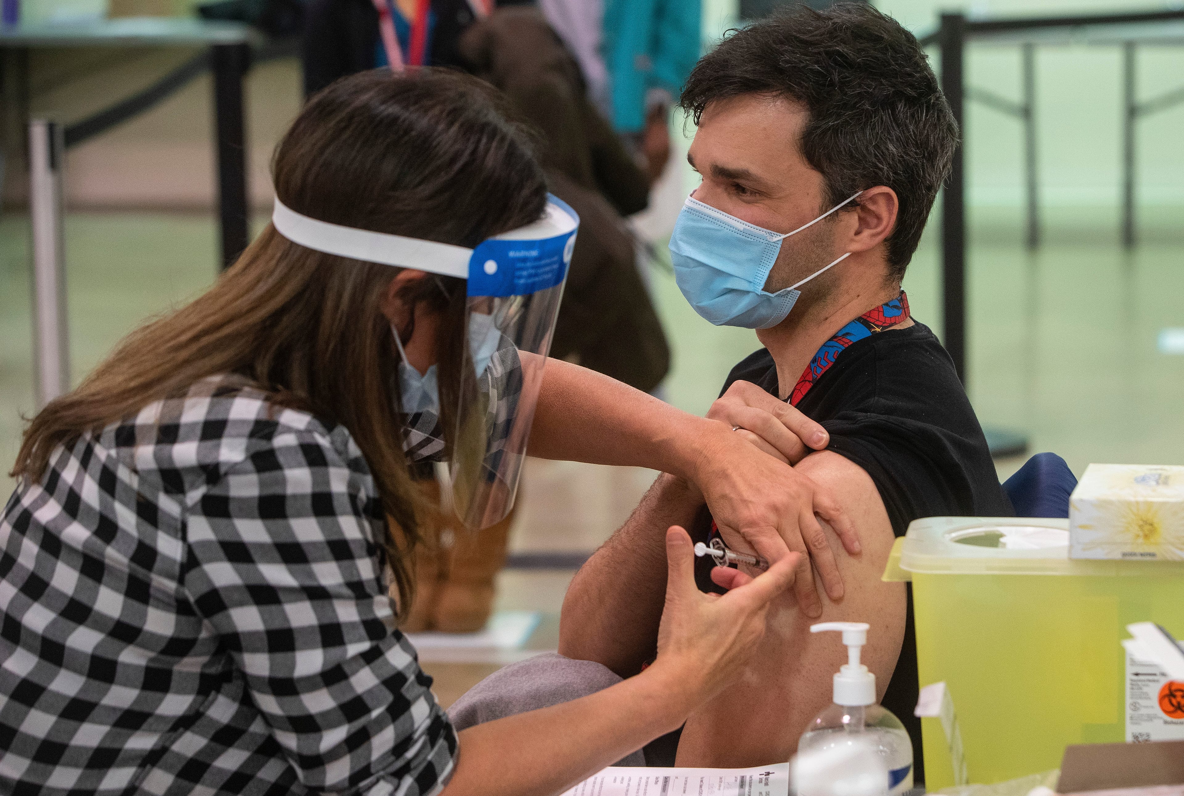 A nurse gives a COVID-19 vaccine in Edmonton, to Castro Arian in Edmonton on Tuesday, December 15, 2020. THE CANADIAN PRESS/Jason Franson