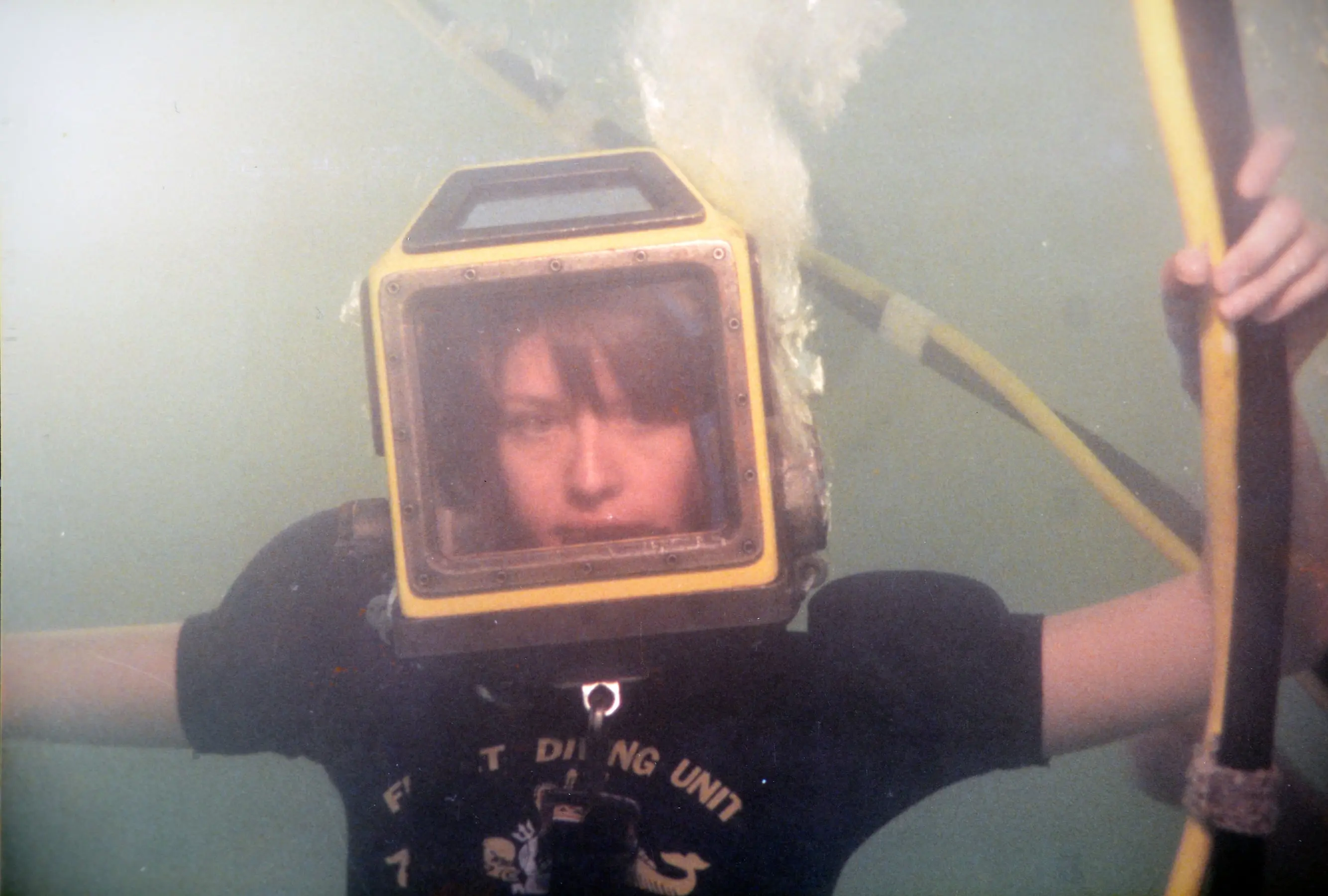 Coveney in 1983 trying a new diving helmet; she was one of the first women posted on a navy ship (Courtesy of Lynn Coveney)