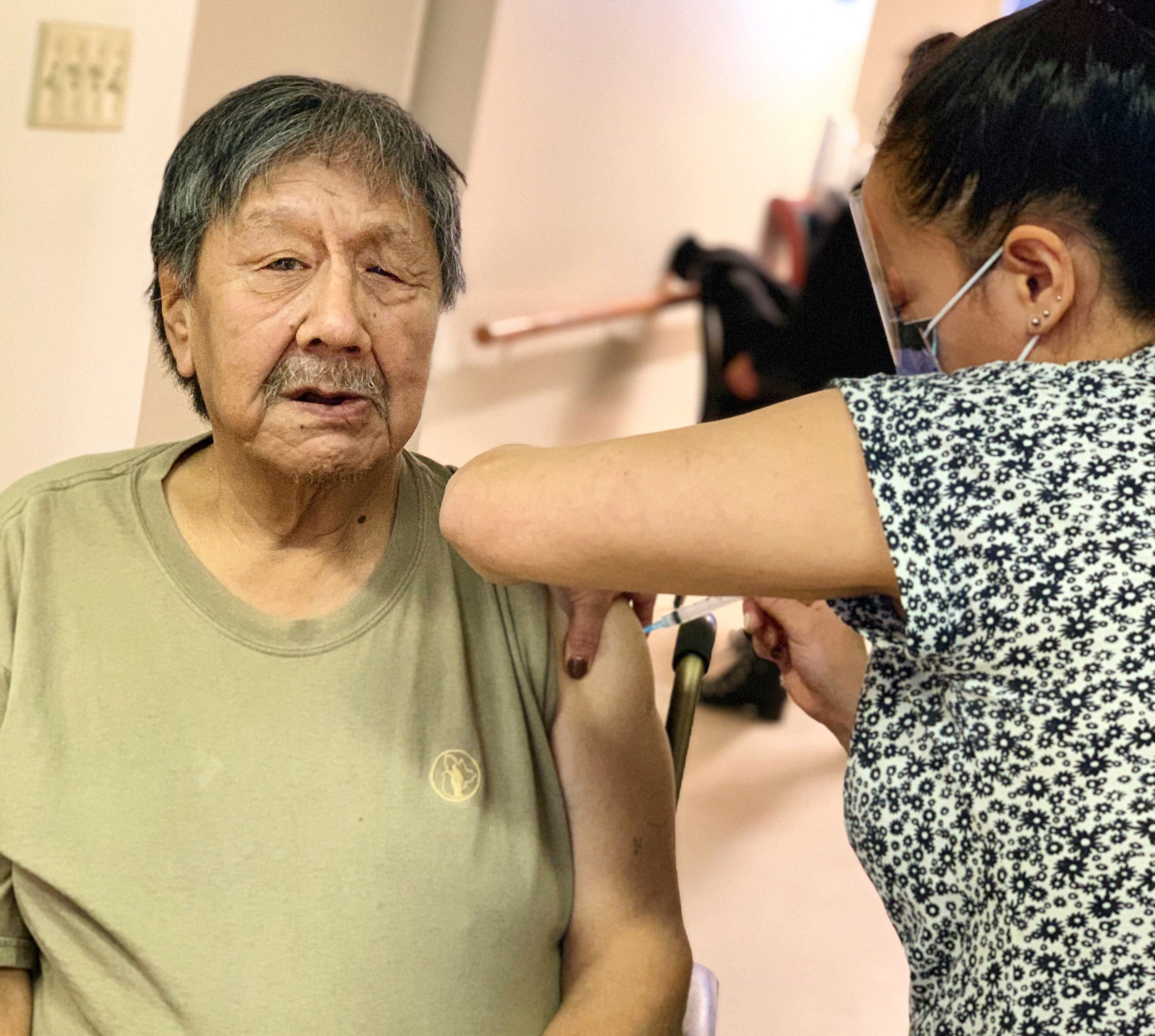 Josephee Adams, 70, a resident of the Iqaluit Elders’ Centre, is Nunavut’s first vaccine recipient. The Moderna vaccine was administered by long-time Iqaluit Public Health nurse Susie Pearce, a graduate of the Nunavut Arctic College’s Bachelor of Science Nursing (Arctic Nursing Program). THE CANADIAN PRESS/HO-Government of Nunavut MANDATORY CREDIT