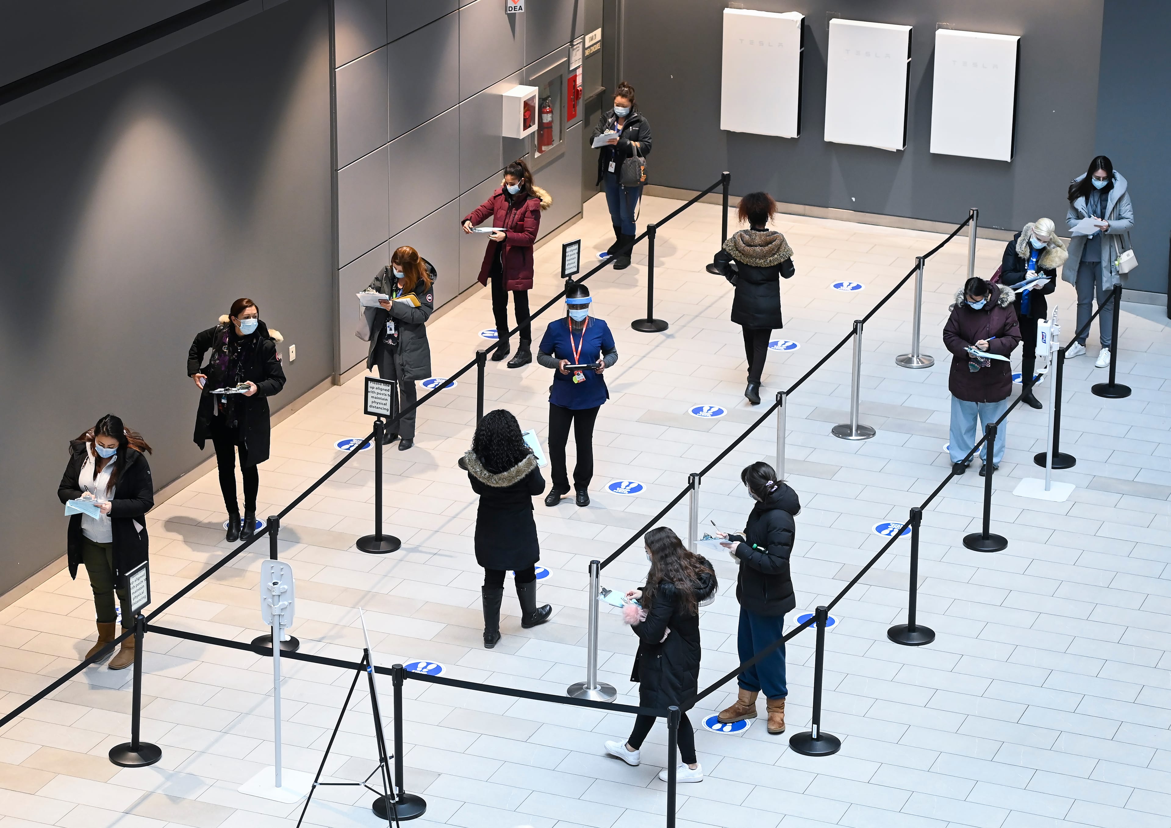 Health-care workers wait in line at a UHN COVID-19 vaccine clinic in Toronto on Thursday, January 7, 2021. THE CANADIAN PRESS/Nathan Denette