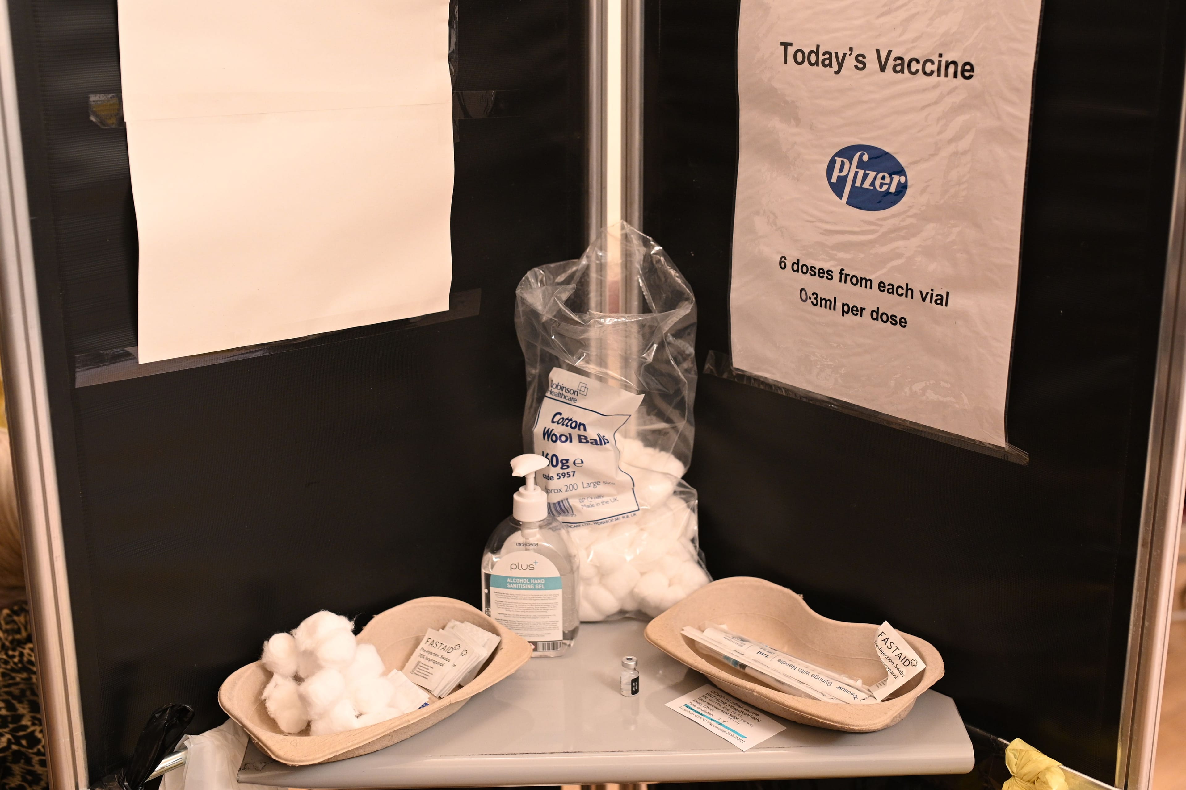 In England, a poster reminds health care professionals that the vaccine they are using is the Pfizer/BioNTech Covid-19 vaccine and that they should draw six doses of 0.3ml from each vial. (Photo by Oli SCARFF / AFP) (Photo by OLI SCARFF/AFP via Getty Images)