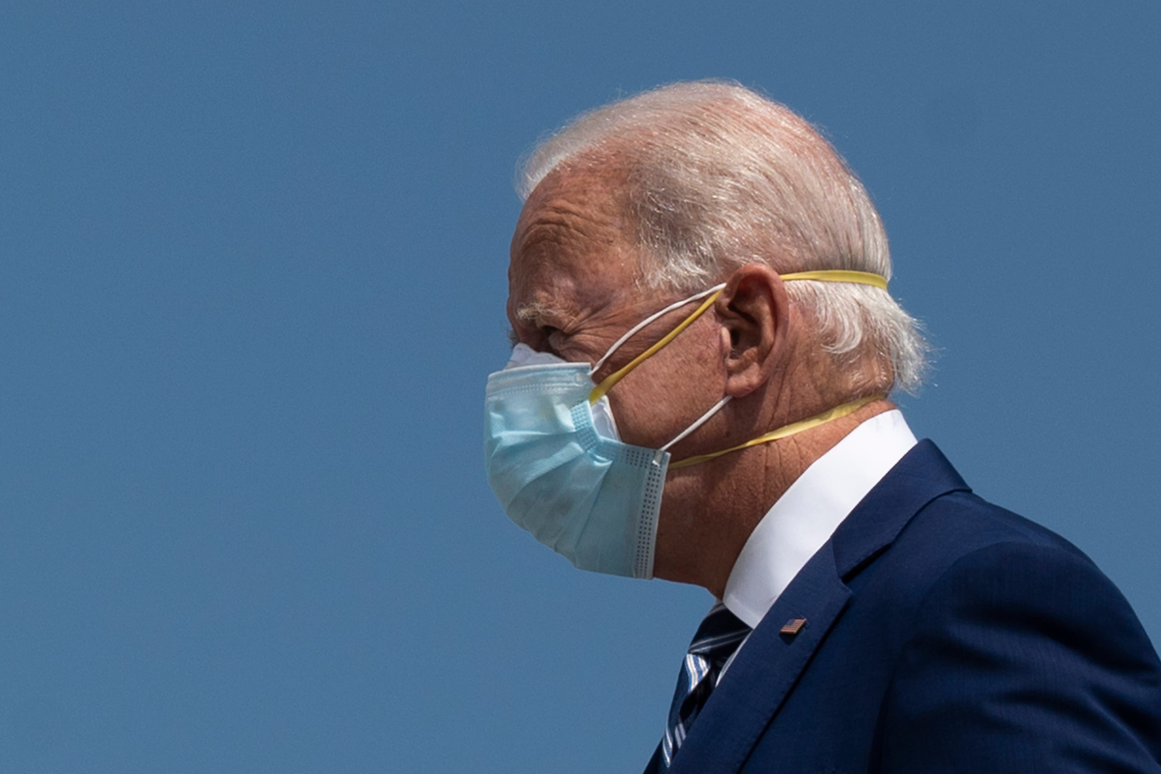 Democratic Presidential Candidate Joe Biden wears two masks as he arrives in Fort Lauderdale, Florida on October 13, 2020. - Joe Biden headed for Florida on Tuesday to court elderly Americans who helped elect Donald Trump four years ago but appear to be swinging to the Democratic candidate for the White House this time around amid the coronavirus pandemic. Biden, at 77 the oldest Democratic nominee ever, is to "deliver his vision for older Americans" at an event in the city of Pembroke Pines, north of Miami, his campaign said. (Photo by JIM WATSON / AFP) (Photo by JIM WATSON/AFP via Getty Images)