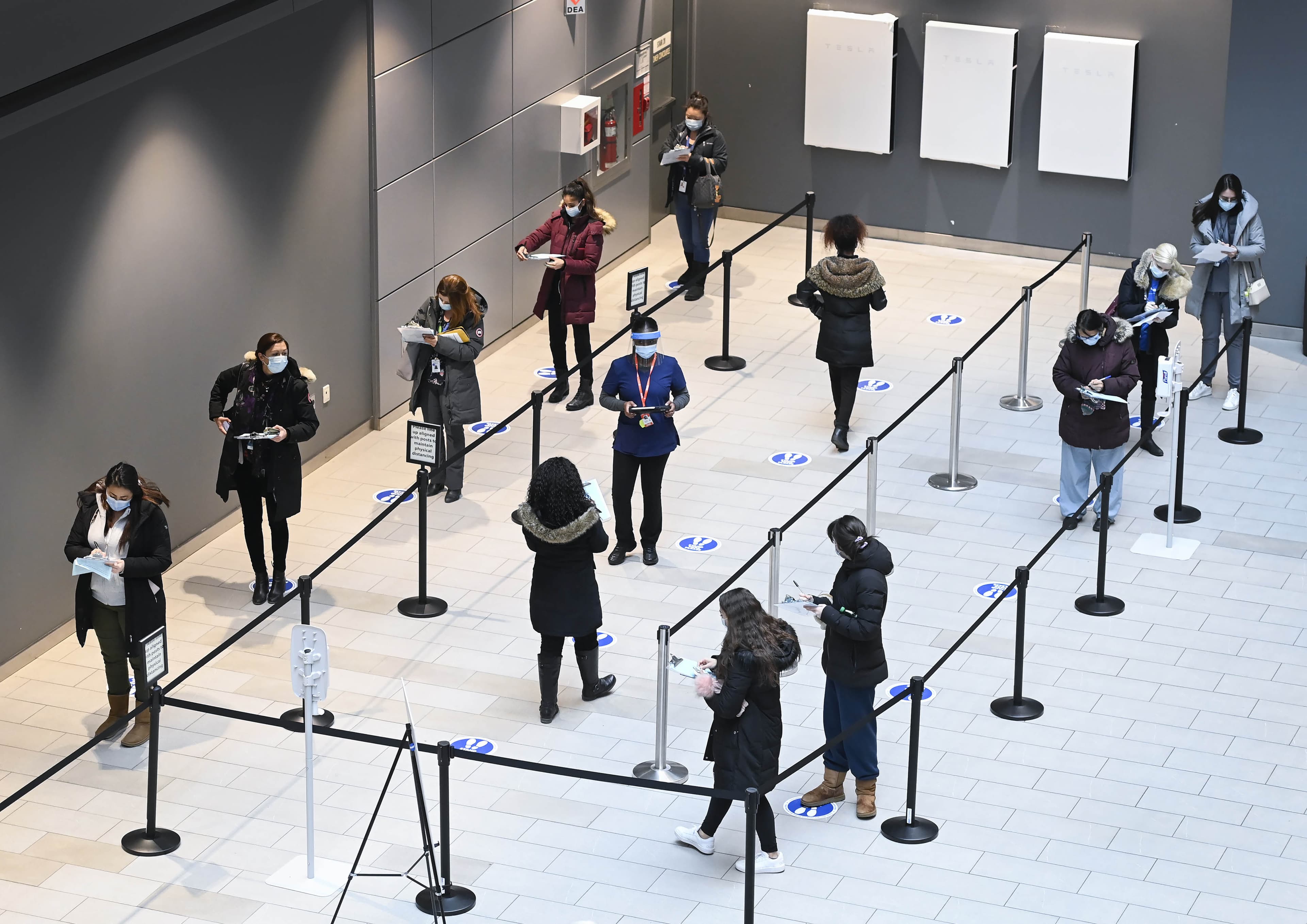 Health-care workers wait in line at a UHN COVID-19 vaccine clinic in Toronto on Thursday, January 7, 2021. (Nathan Denette/CP)