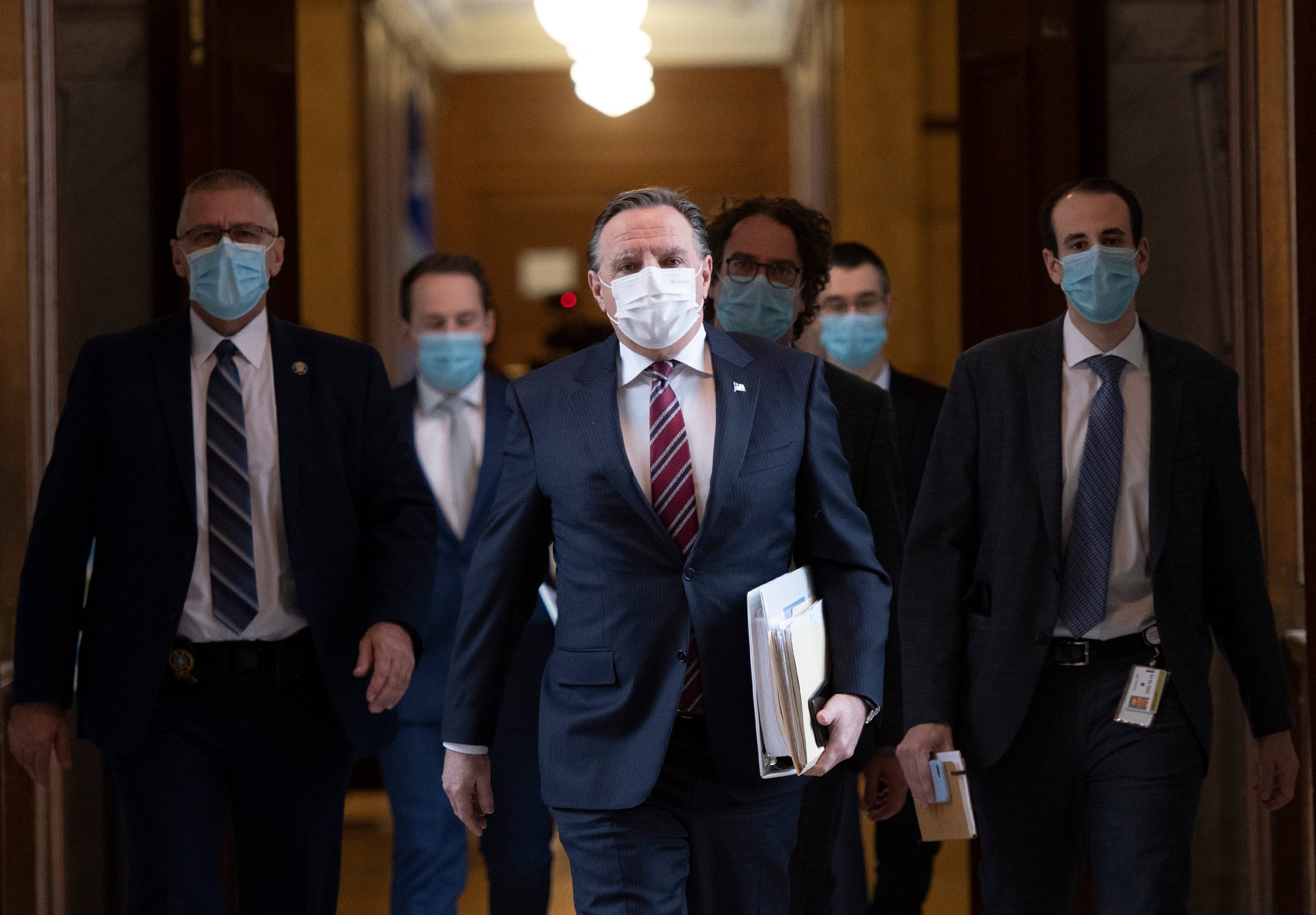Legault walks to Question Period with members of his staff as the legislature resumes for its spring session on Feb. 2, 2021 in Quebec City (CP/Jacques Boissinot)
