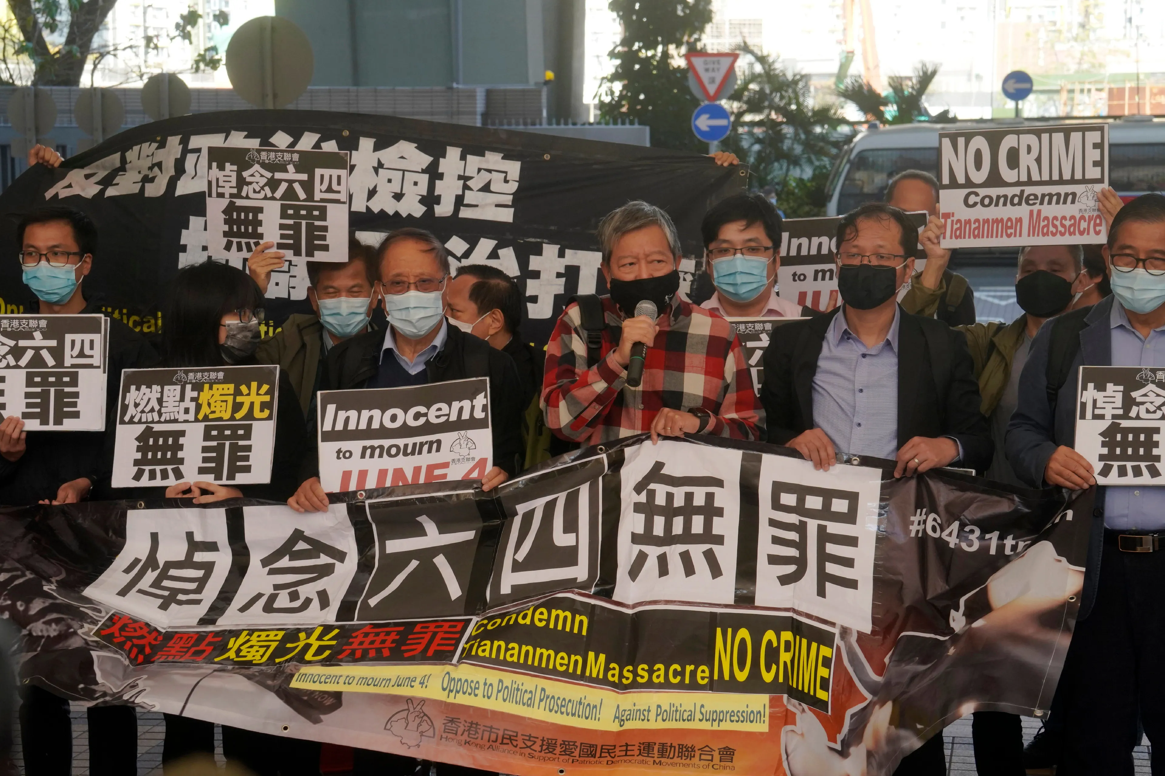 Pro-democracy protestors gather Friday during the court appearance in Hong Kong of two dozen activists charged with unauthorized assembly; the accused had attended a vigil commemorating the 1989 Tiananmen crackdown.(Kin Cheung/AP)