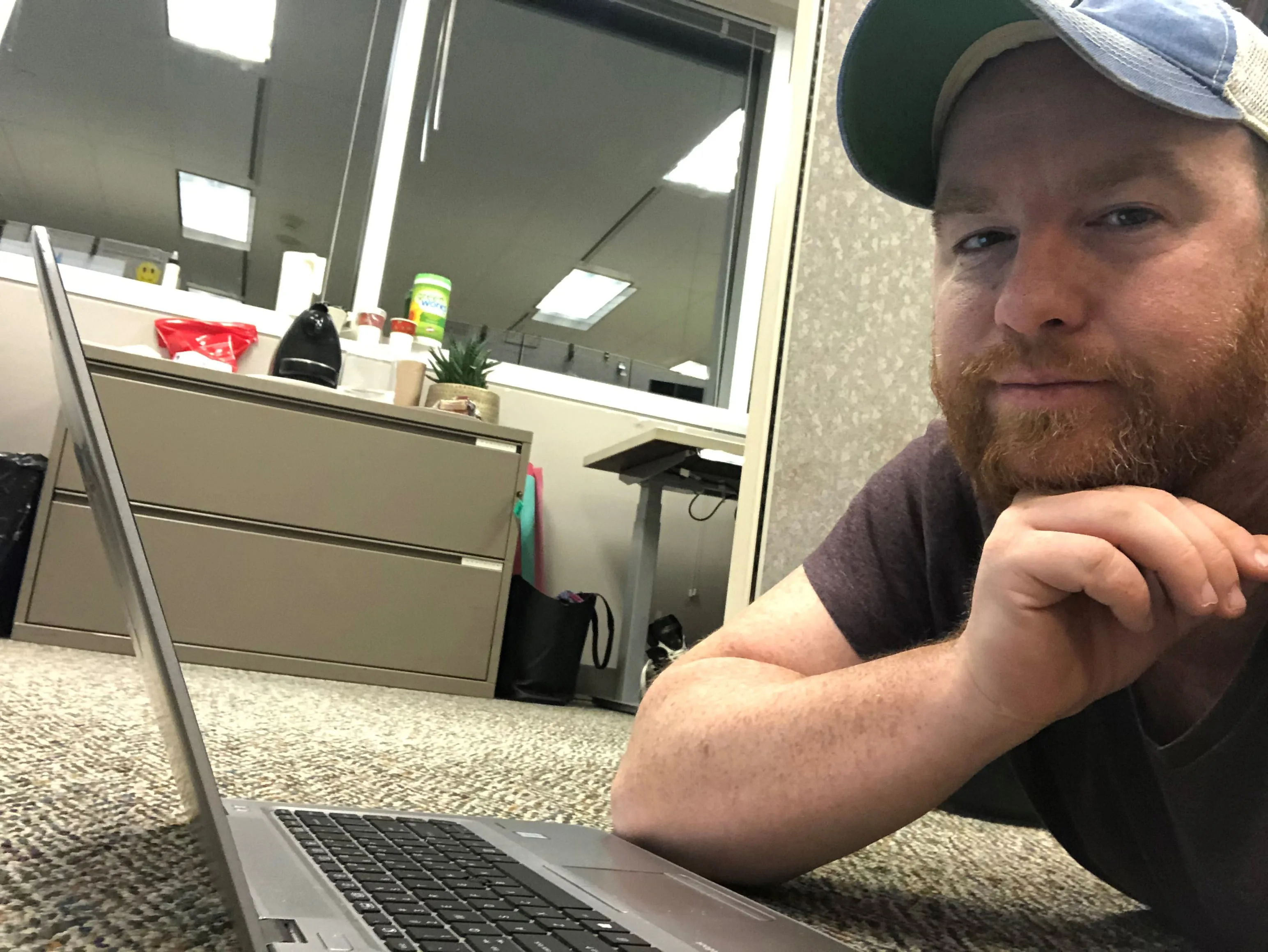 A selfie Kevin Parent sent to his wife at 10:30 on a Sunday night early in the pandemic, when he was sprawled on the floor of his office writing copy for the Ottawa International Airport to display on its information screens (Courtesy of Kevin Parent)