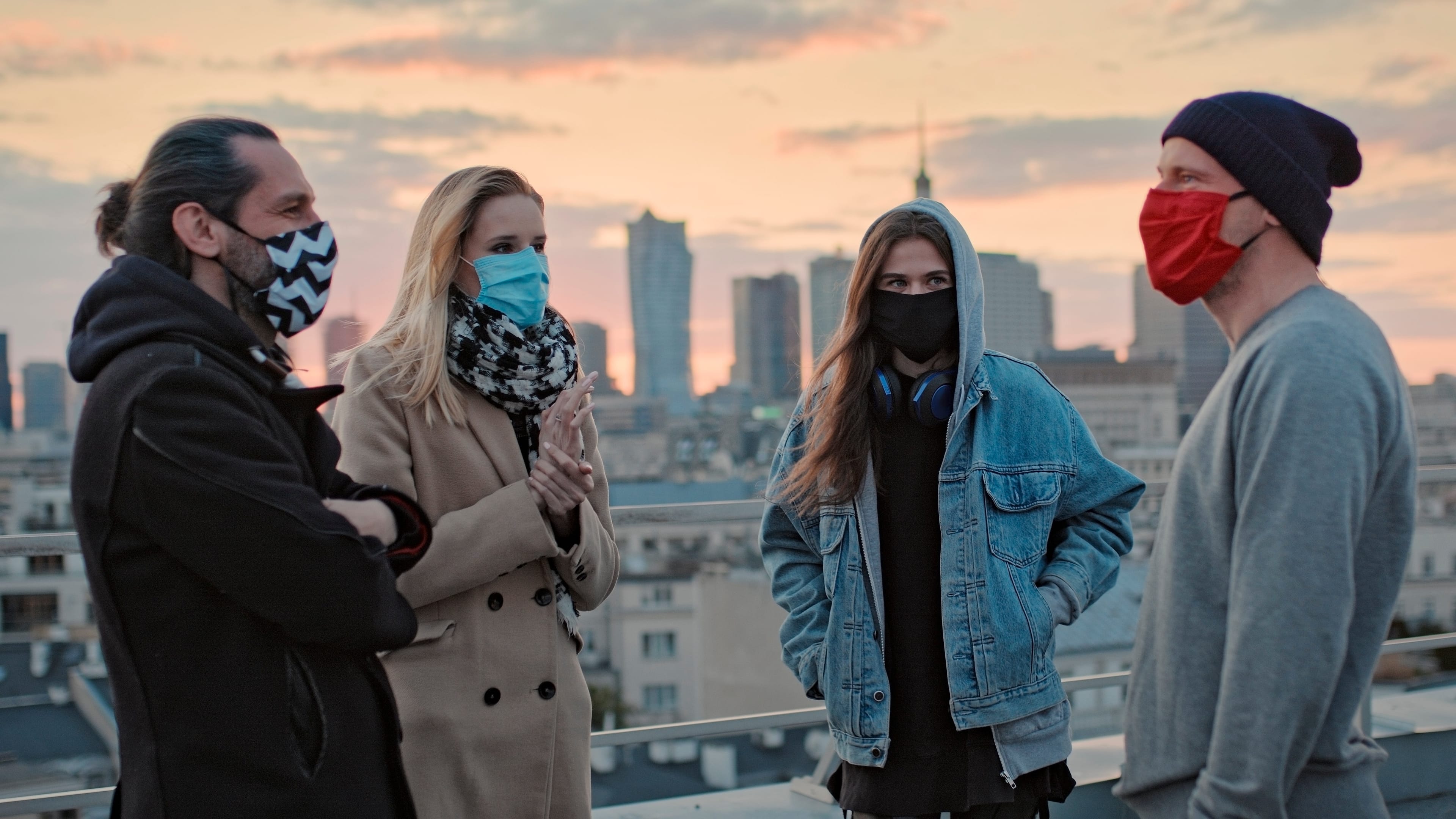 Young people meeting on a rooftop. Wearing masks and keeping distance