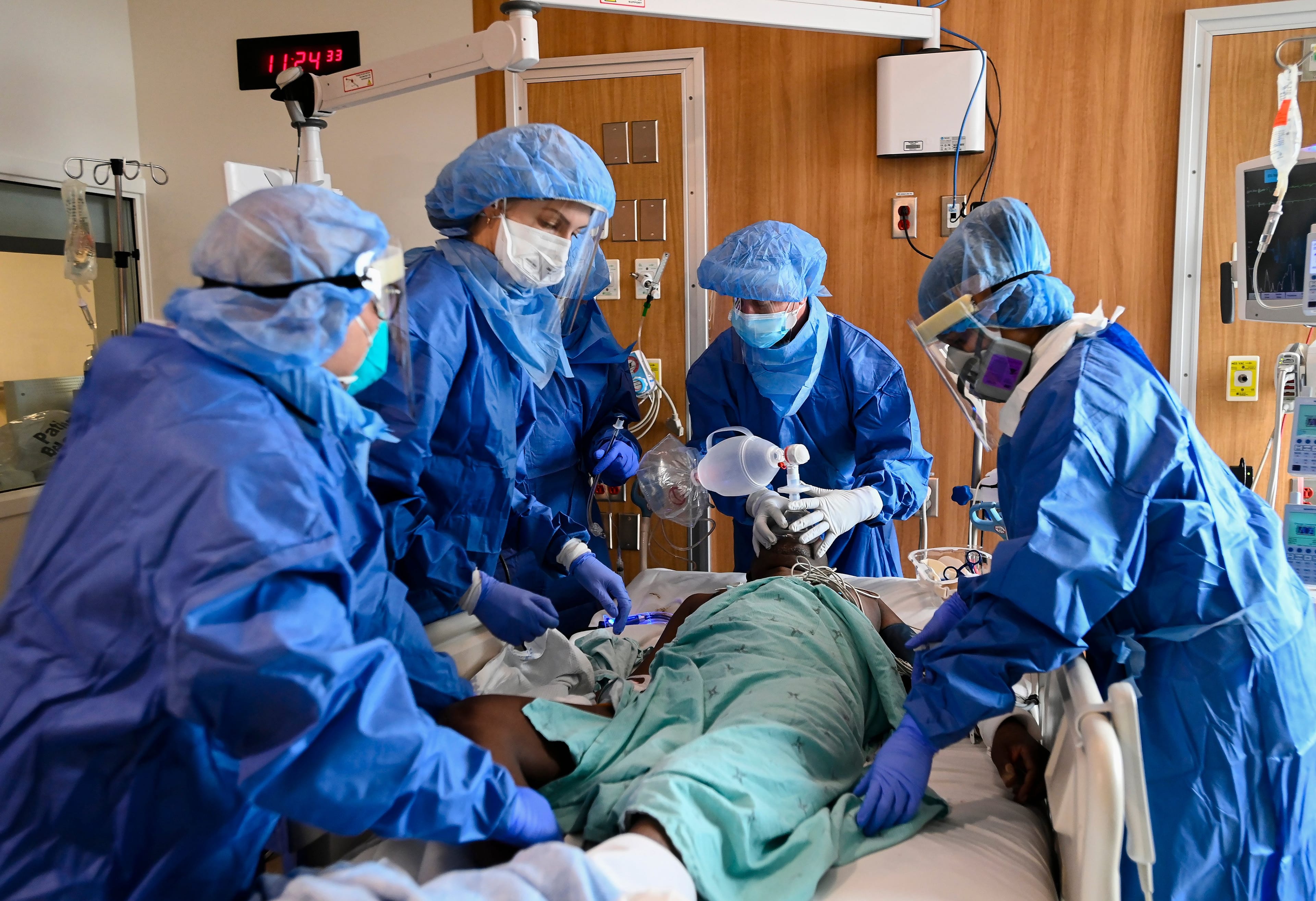 A 60-year-old COVID-19 patient fights for his life, desperately gasping for air as health-care staff provide life saving medical care in an emergency situation in the intensive care unit at the Humber River Hospital during the COVID-19 pandemic in Toronto on Tuesday, April 13, 2021. The patient was intubated and put on a ventilator successfully. (Nathan Denette/CP)