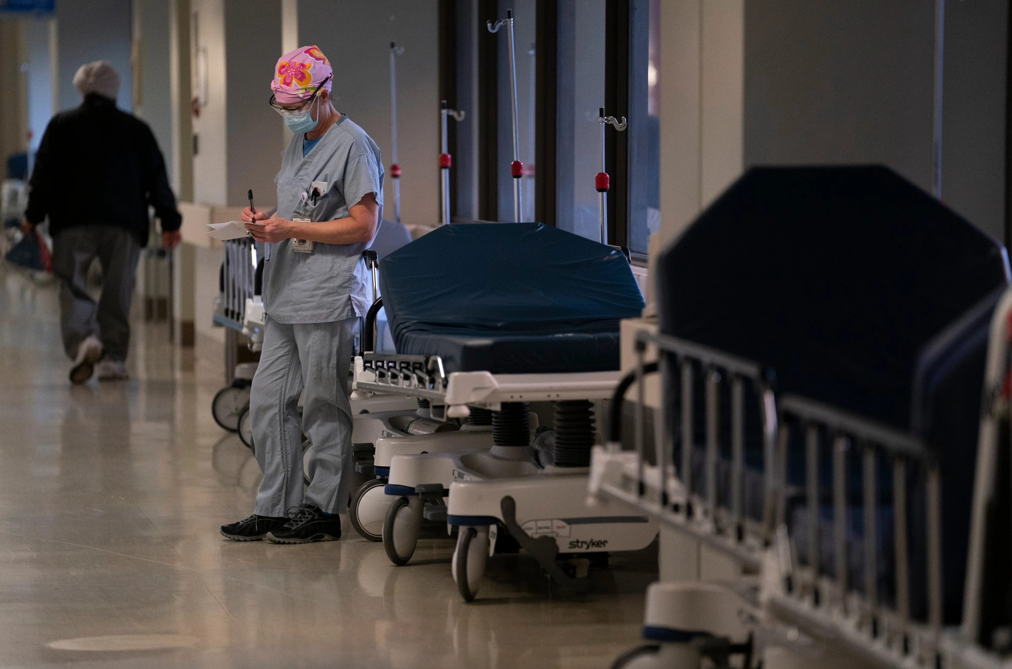 An intensive care unit nurse takes a moment to write some notes during her shift at a Vancouver hospital on Dec. 4, 2020 (CP/Jonathan Hayward)