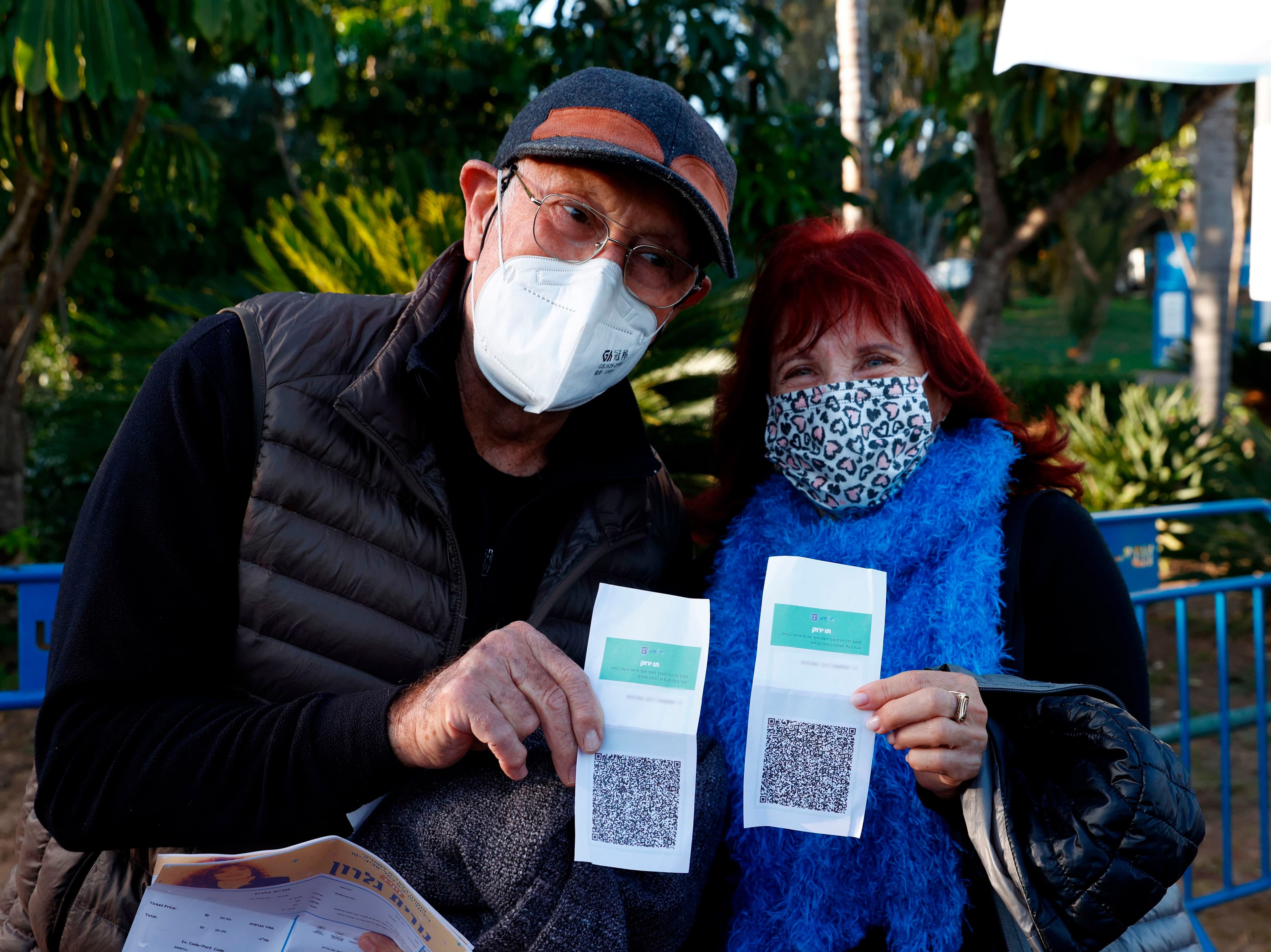 Two Israelis show their printed-out codes before attending a Green Pass concert in Tel Aviv (Jack Guez/AFP/Getty Images)