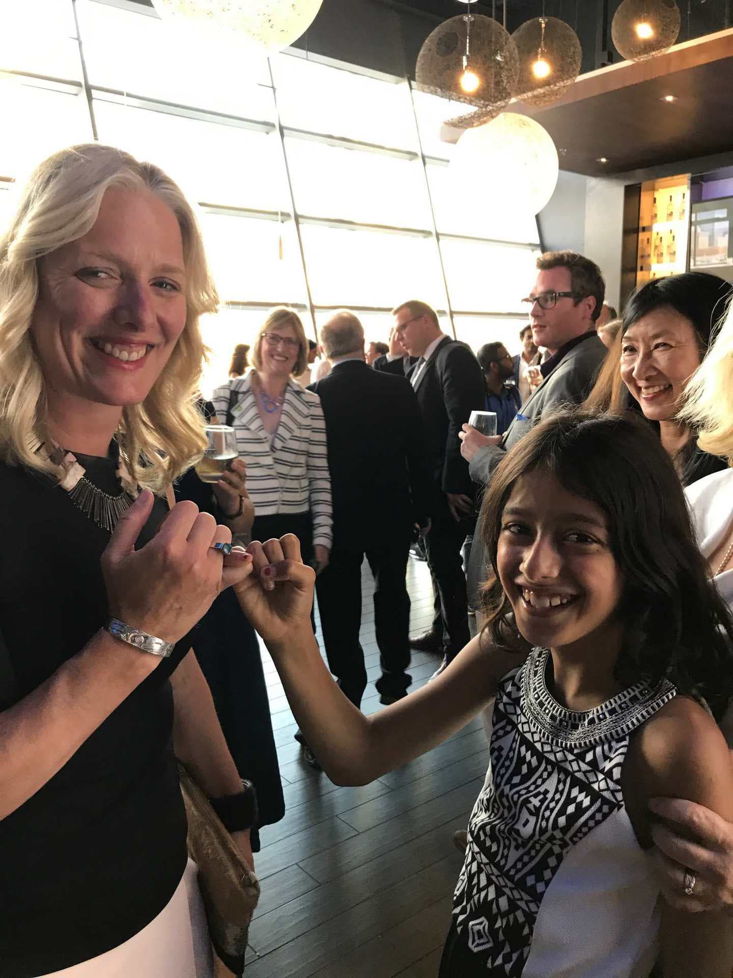 Mathur pinky swearing to tackle climate change with then Minister of Environment and Climate Change Catherine McKenna, in 2017 (Courtesy of Sophia Mathur)